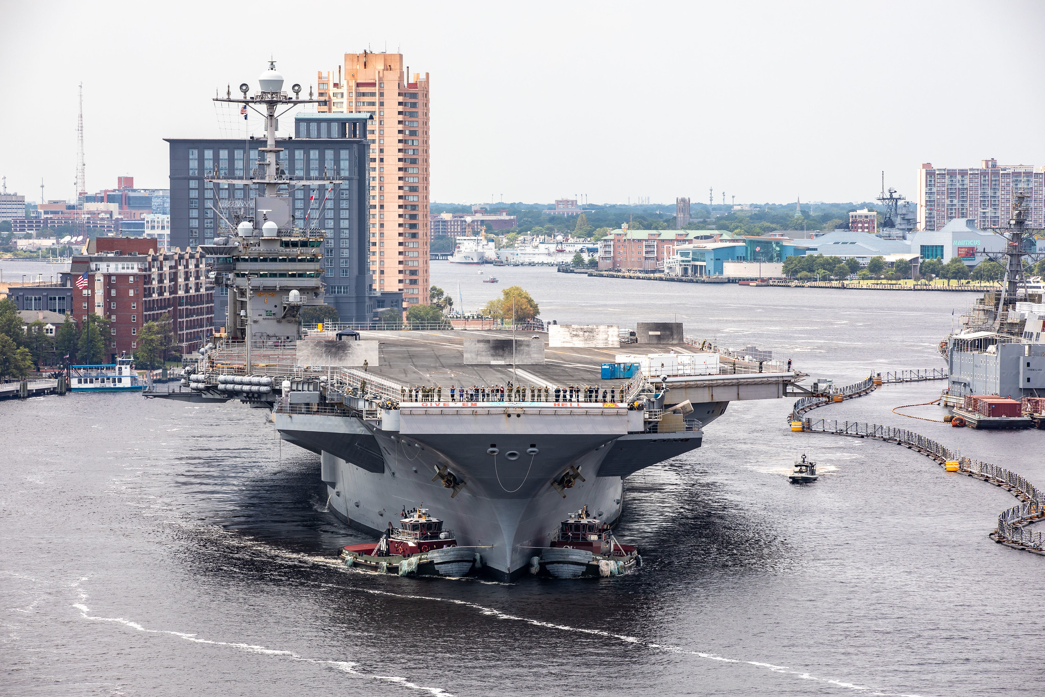 The aircraft carrier USS Harry S. Truman (CVN 75) arrives at Norfolk Naval Shipyard, July 7, 2020, for an extended carrier incremental availability. (U.S. Navy photo by Shelby West/Released) 200707-N-YO710-002. Image via Flickr.com, CC BY 2.0.