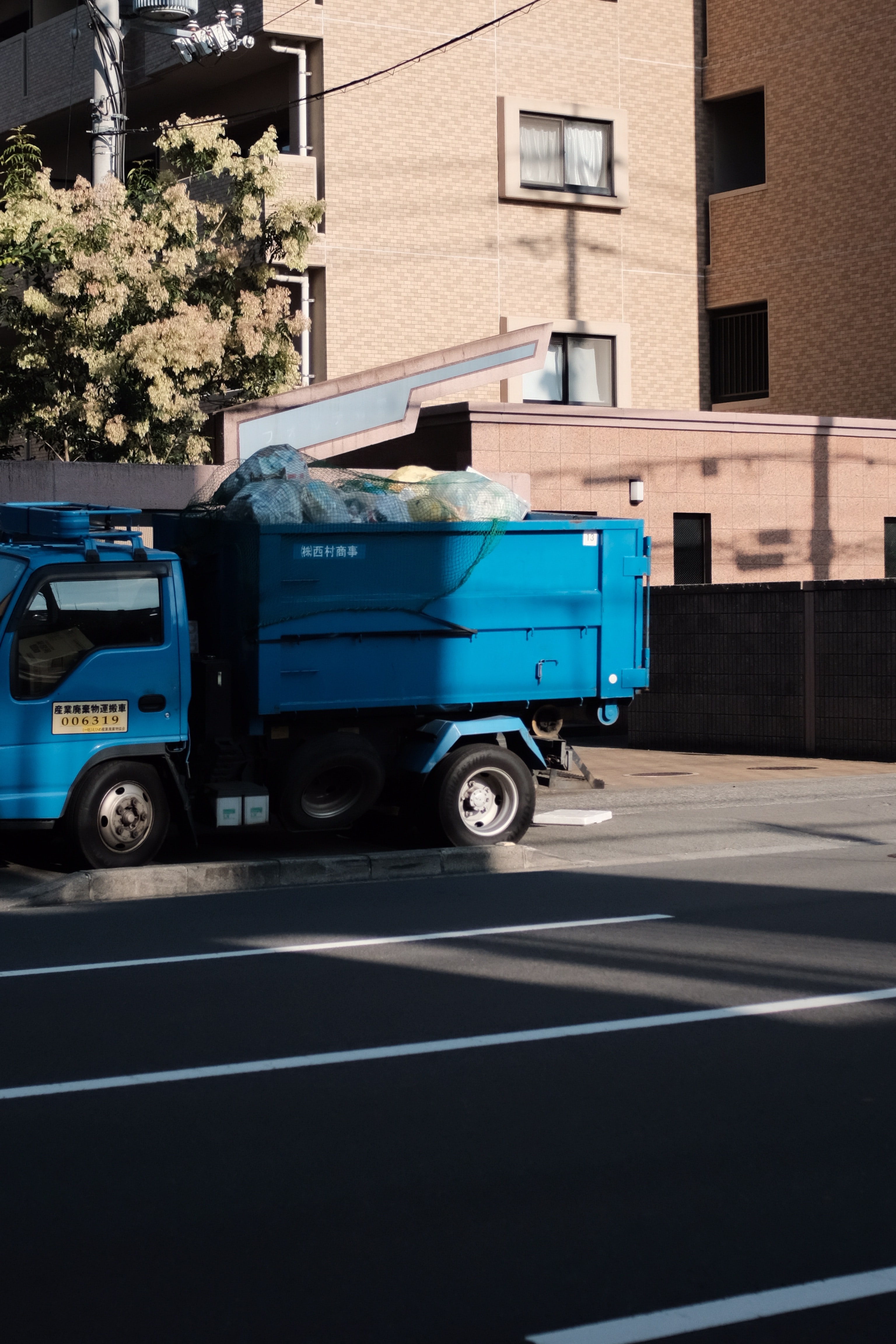 Blue dump truck; image by Mak, via Unsplash.com.
