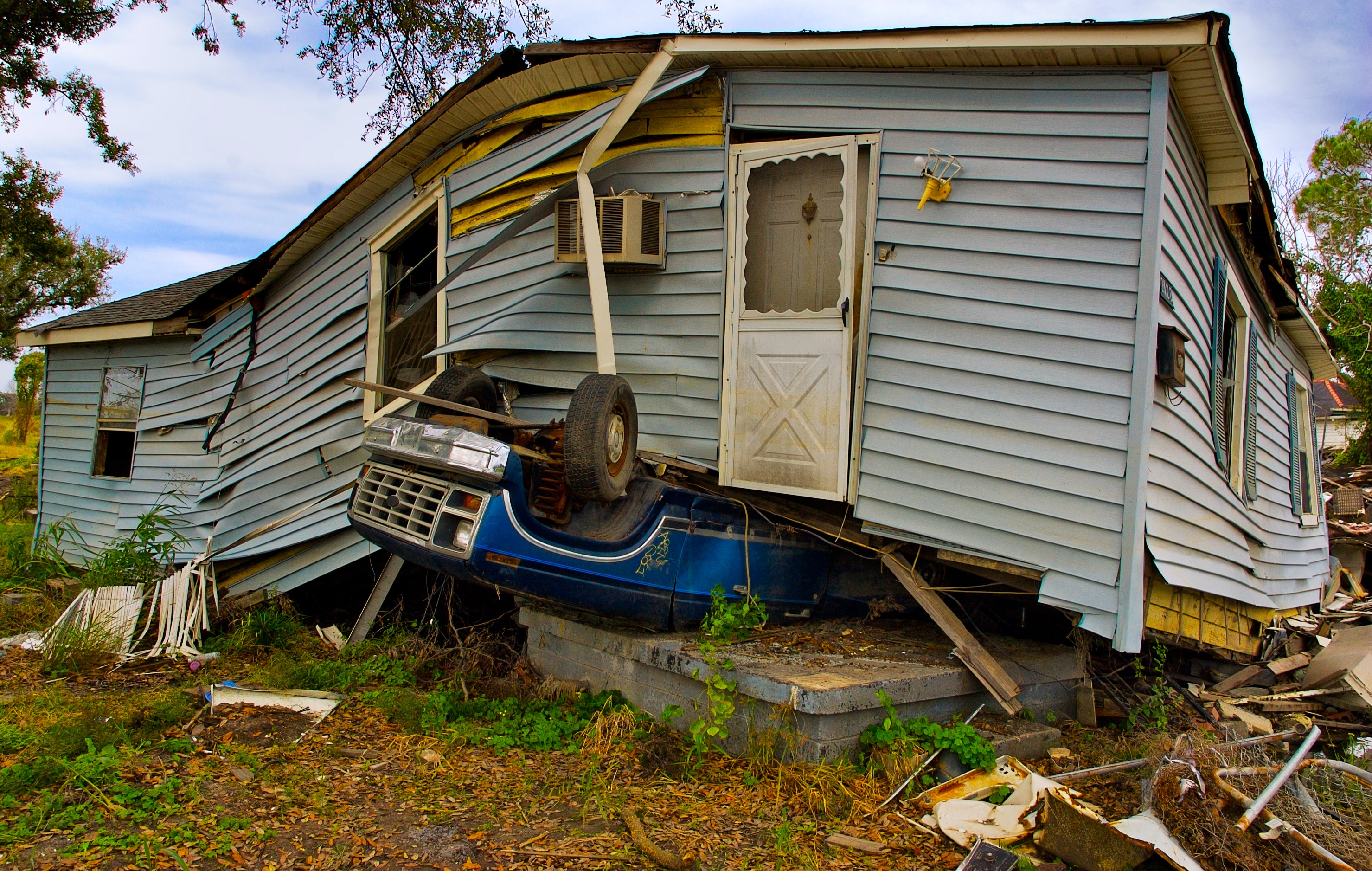 House on top of overturned vehicle; image by John Middelkoop, via Unsplash.com.
