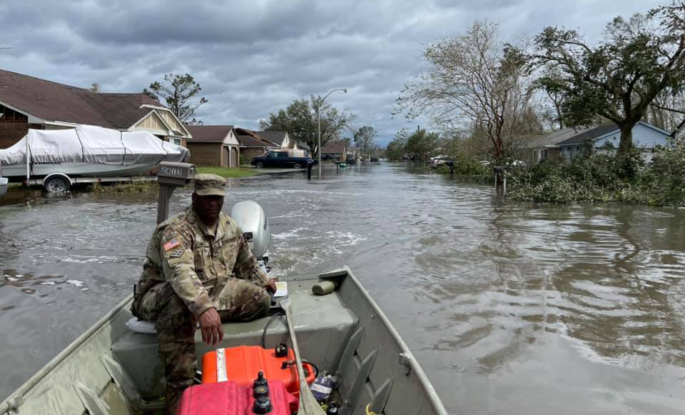 Louisiana National Guardsman in rescue boat, after Hurricane Idak Laplace, LA;.image by The National Guard, via Flickr, CC BY 2.0.