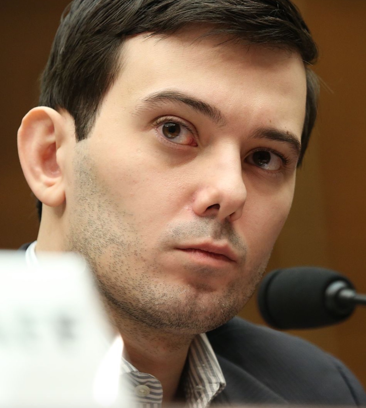 Martin Shkreli testifying before the House Committee on Oversight and Government Reform, 2016. Image by House Committee on Oversight and Government Reform, Public domain, via Wikimedia Commons.