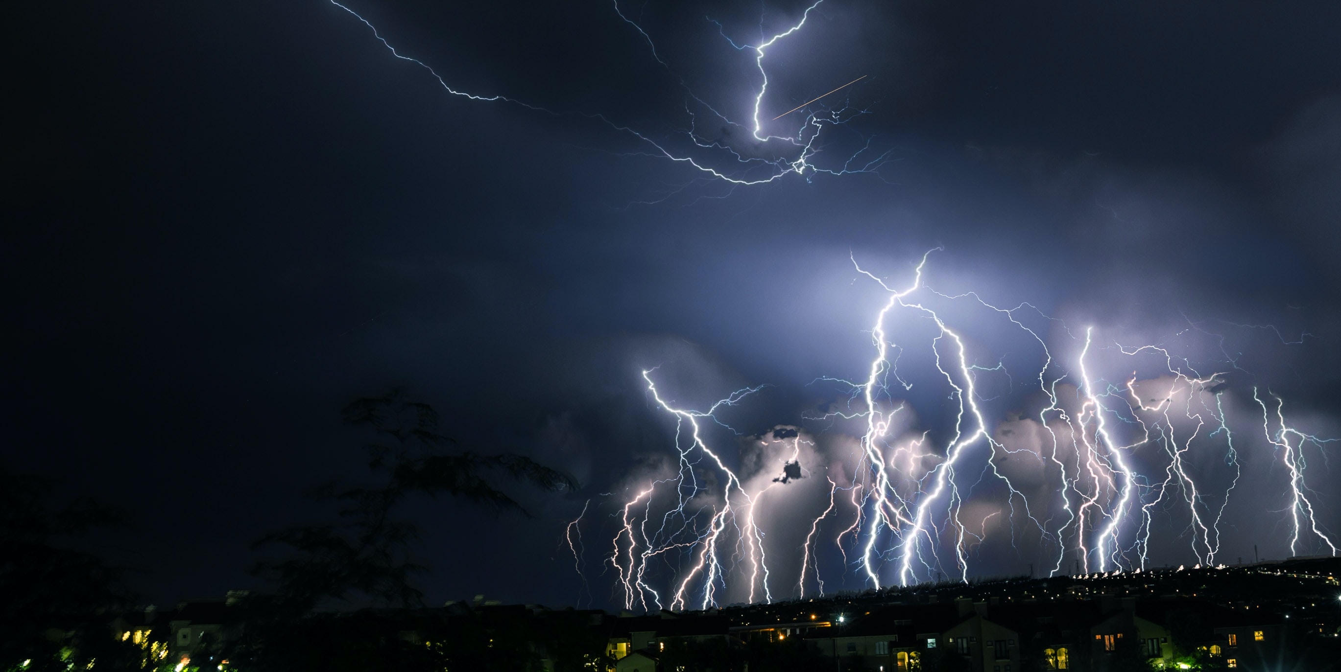 Massive lightning strikes over city; image by Clinton Naik, via Unsplash.com