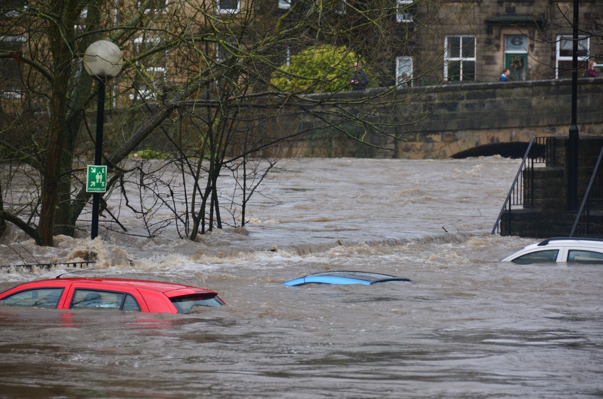 Three cars submerged in flood waters; image by Chris Gallagher, via Unsplash.com.