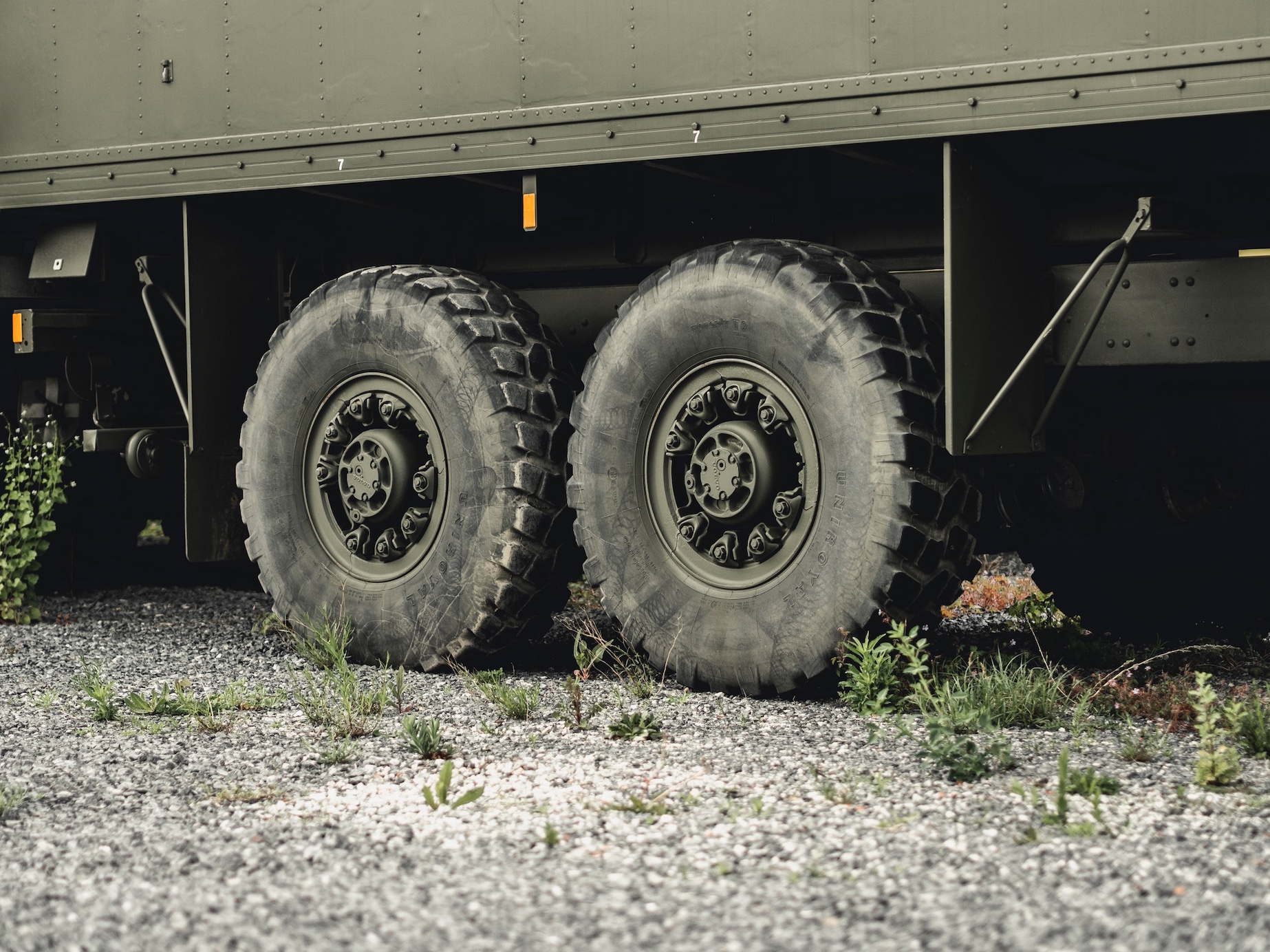 Upclose shot of semi-truck tires; image by Milan DeGraeve, via Unsplash.com.