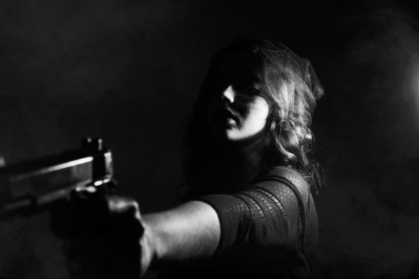 Woman aiming gun; image by Pexels, via Pixabay.com.