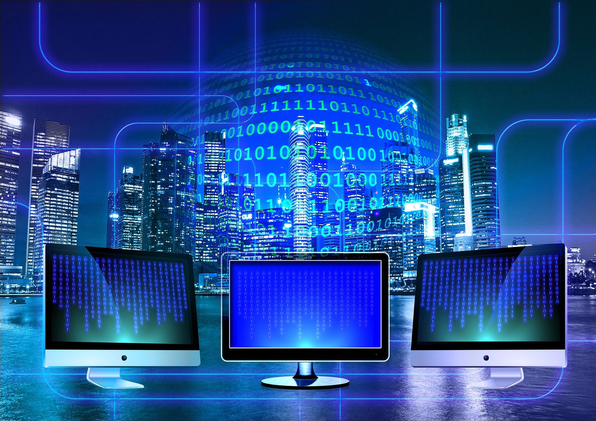 Computer monitors and binary code in front of cityscape at night; image by Geralt, via Pixabay.com.