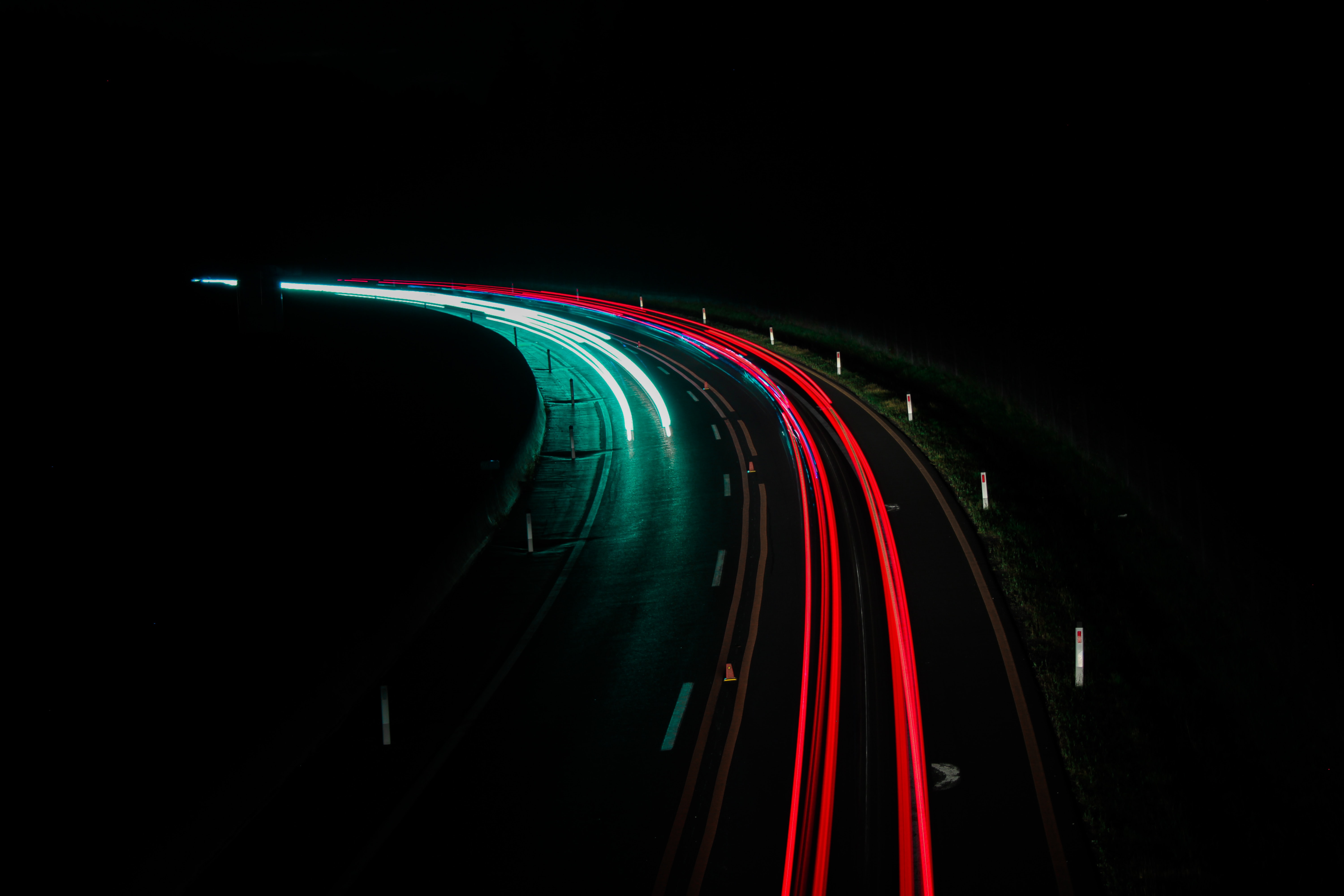 Highway at night, vehicle lights as streaks in the dark; image by Victoria Paar, via Unsplash.com.