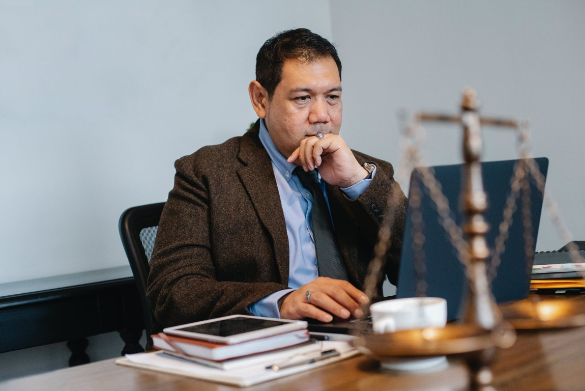 Lawyer working at desk; image by Sora Shimazaki, via Unsplash.com.