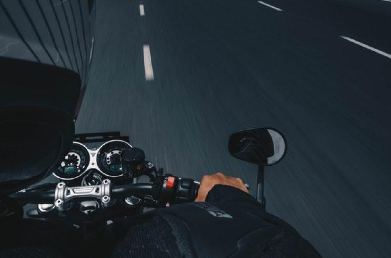 Point of view shot of motorcycle console and handlebar; image by Sourav Mishra via Pexels.com.
