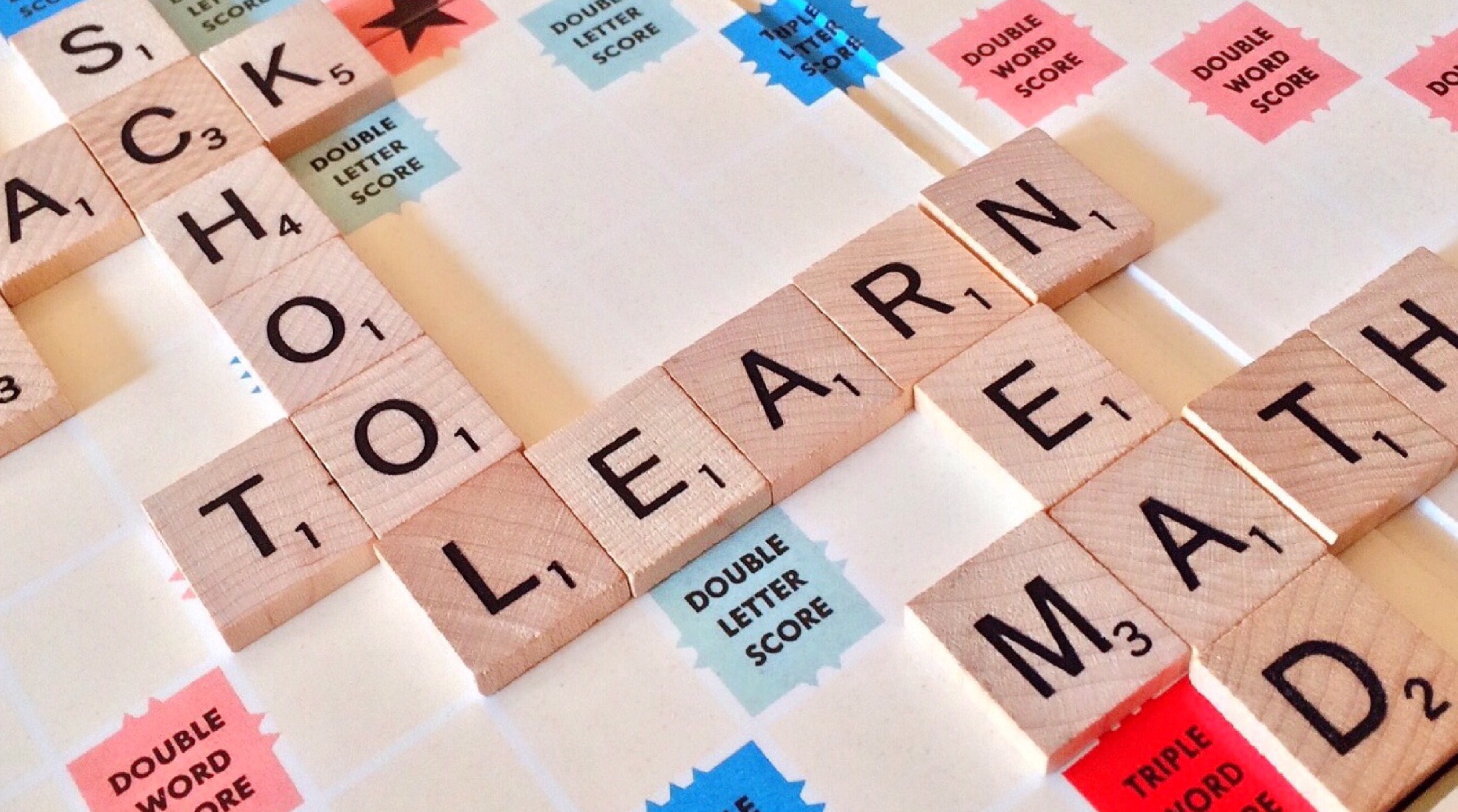 Scrabble tiles spelling out Learning and School; image by Pixabay, via Pexels.com.