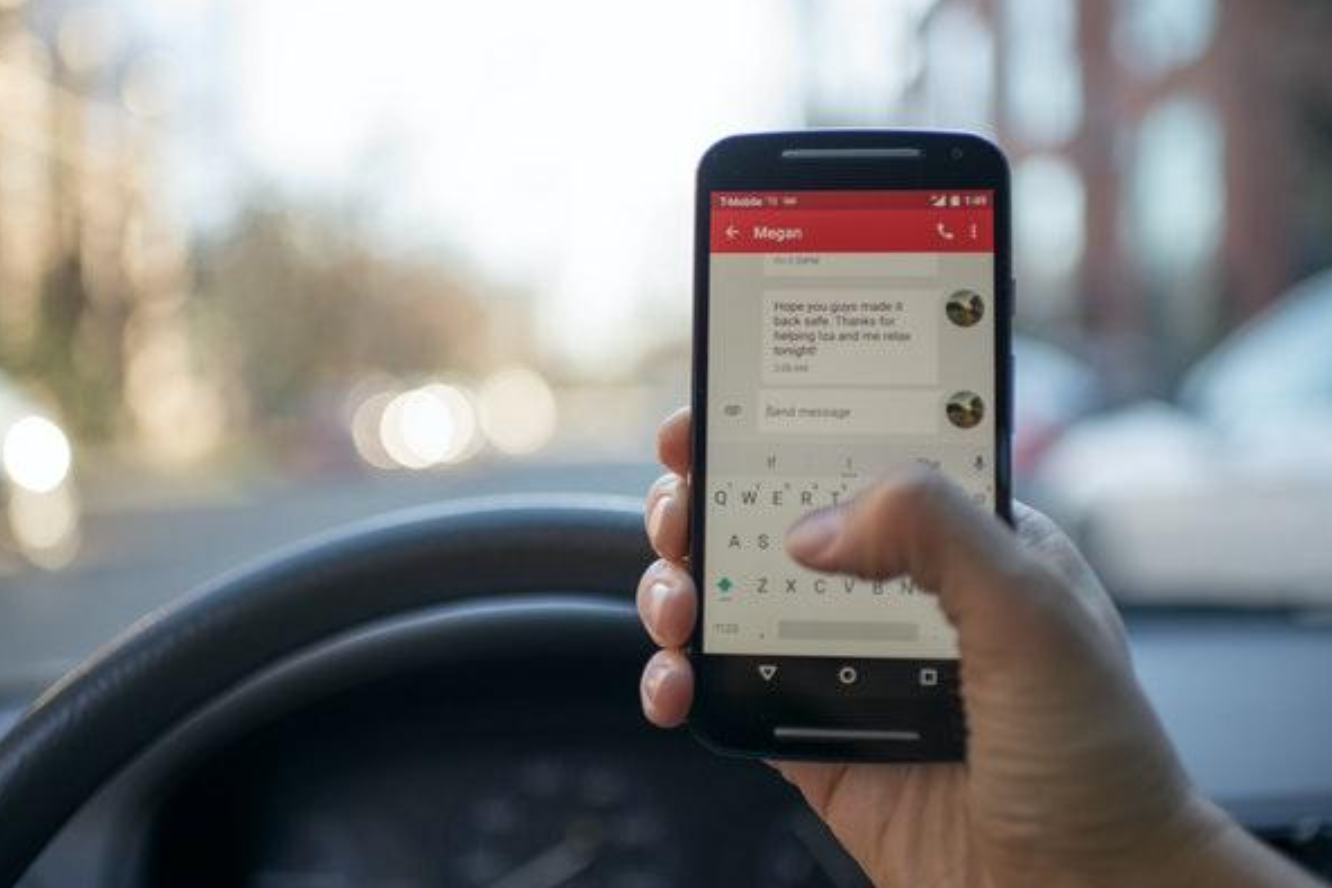 Driver using cell phone; Photo by Roman Pohorecki from Pexels.com.