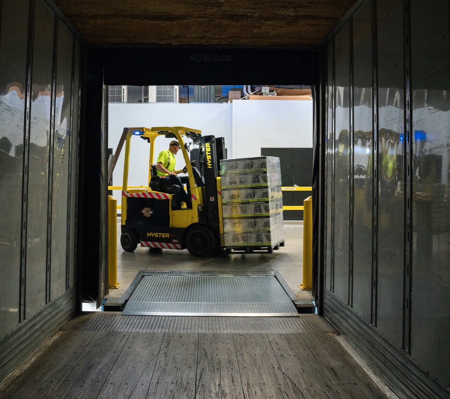 Forklift loading boxes into trailer; image by Elevate, via Unsplash.com.