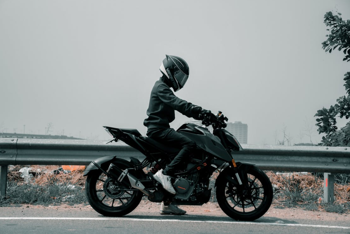 Person riding a motorcycle; image by Akshay Bineesh, via Pexels.com.