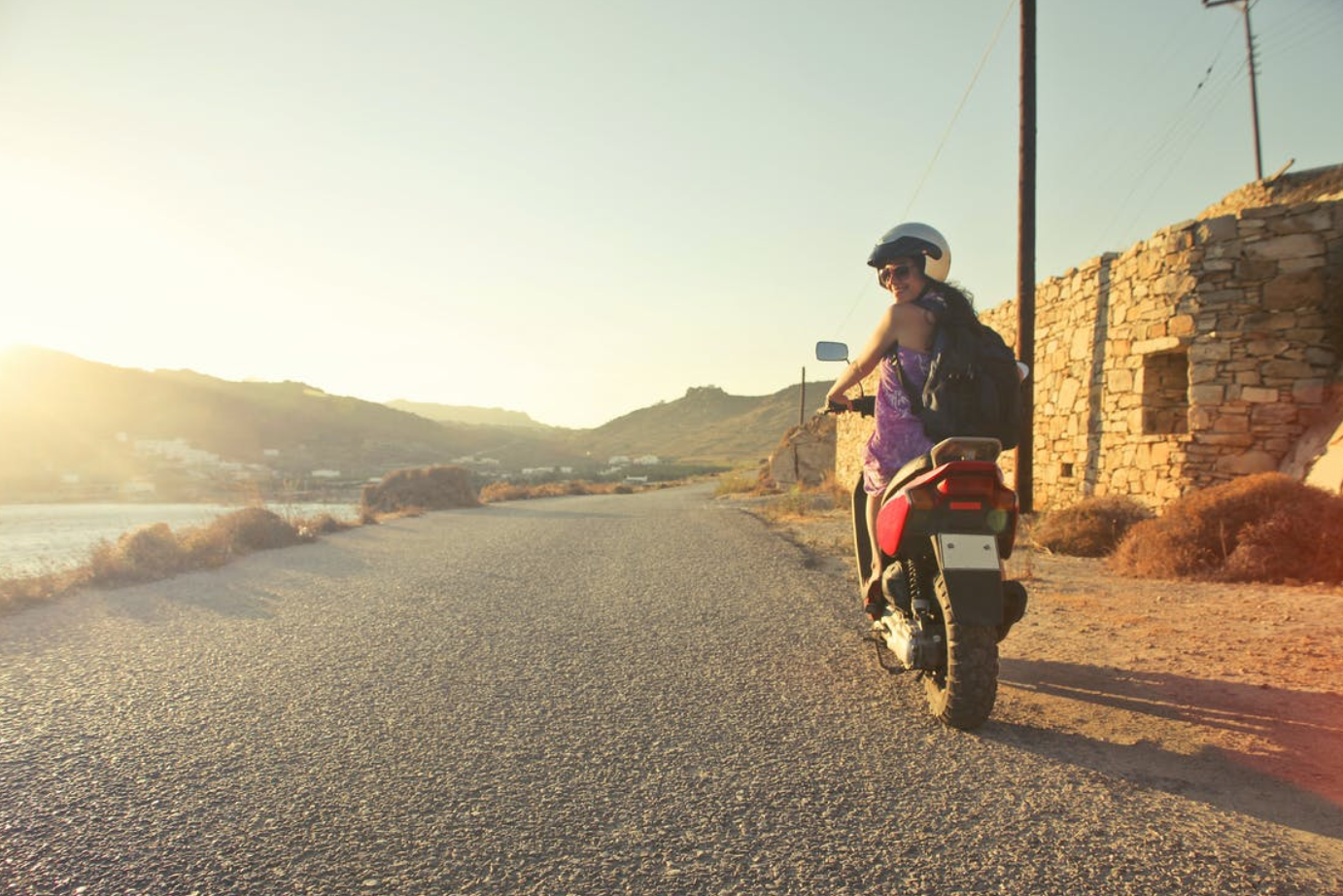 Woman riding motorcycle; image by Andrea Piacquadio, via Pexels.com.