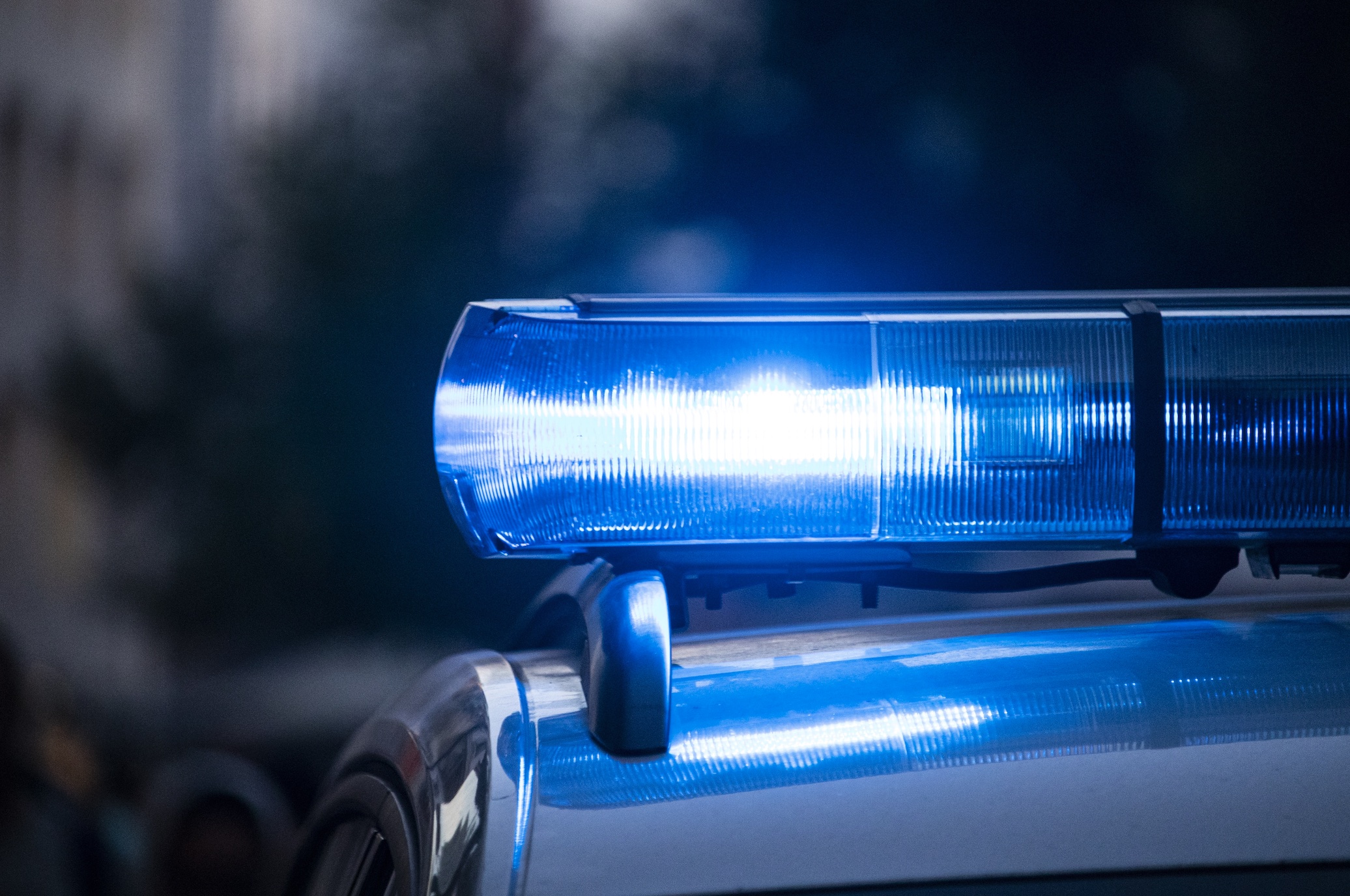 Blue police light; image by Max Fleischmann, via Unsplash.com.