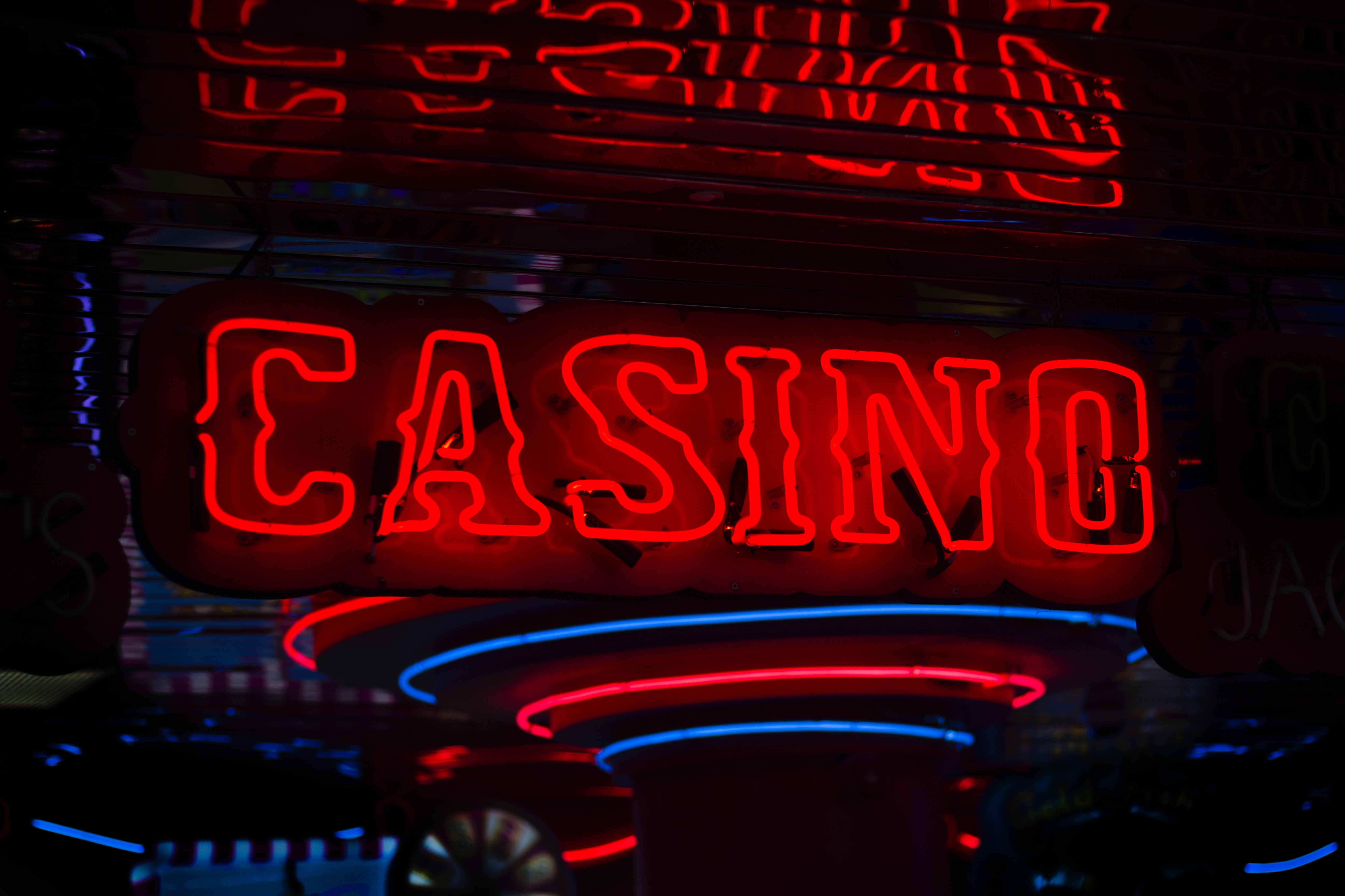 Red casino sign turned on; image by Ben Lambert, via Unsplash.com.