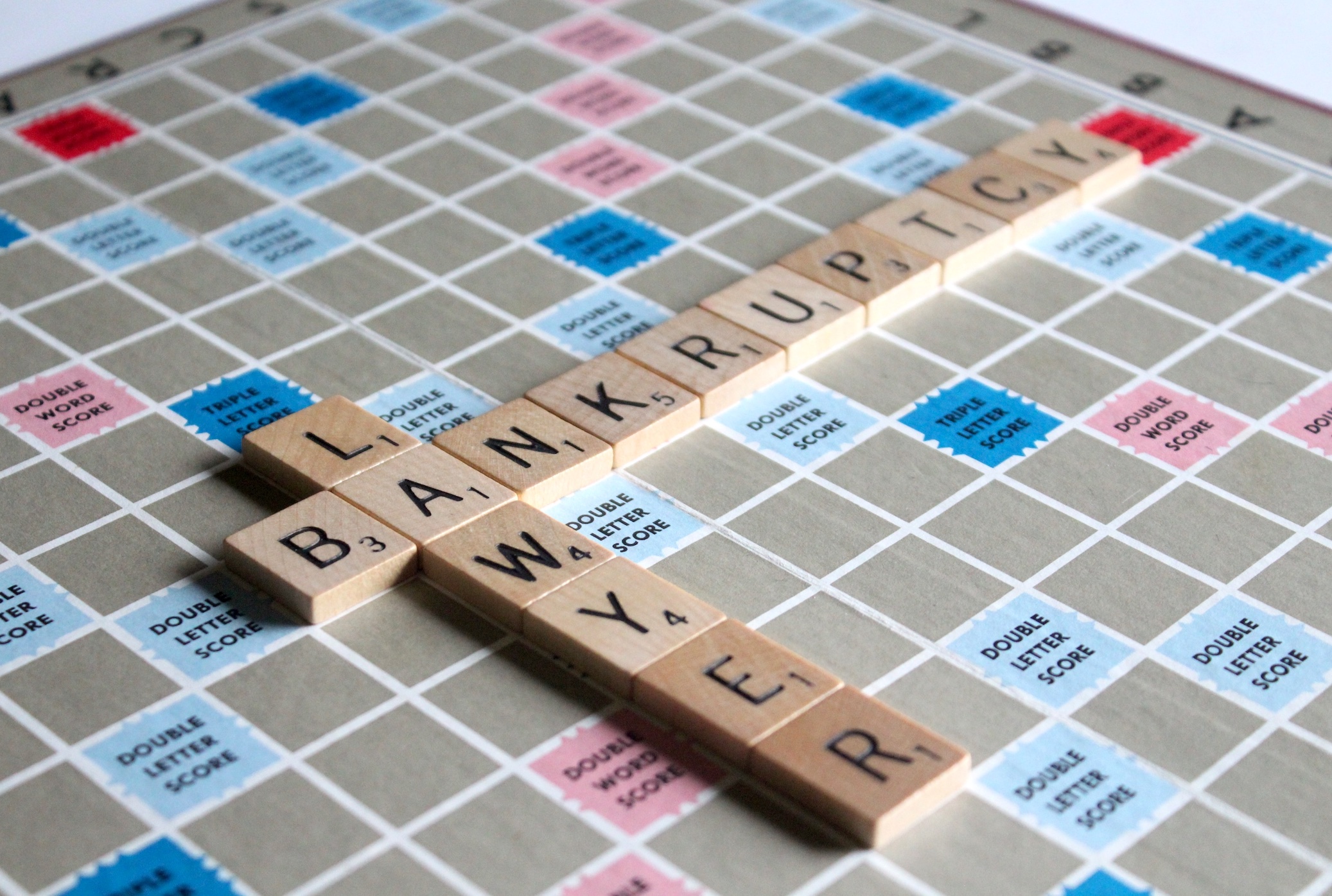 Scrabble board with tiles spelling bankruptcy lawyer. Image by Melinda Gimpel, via Unsplash.com.