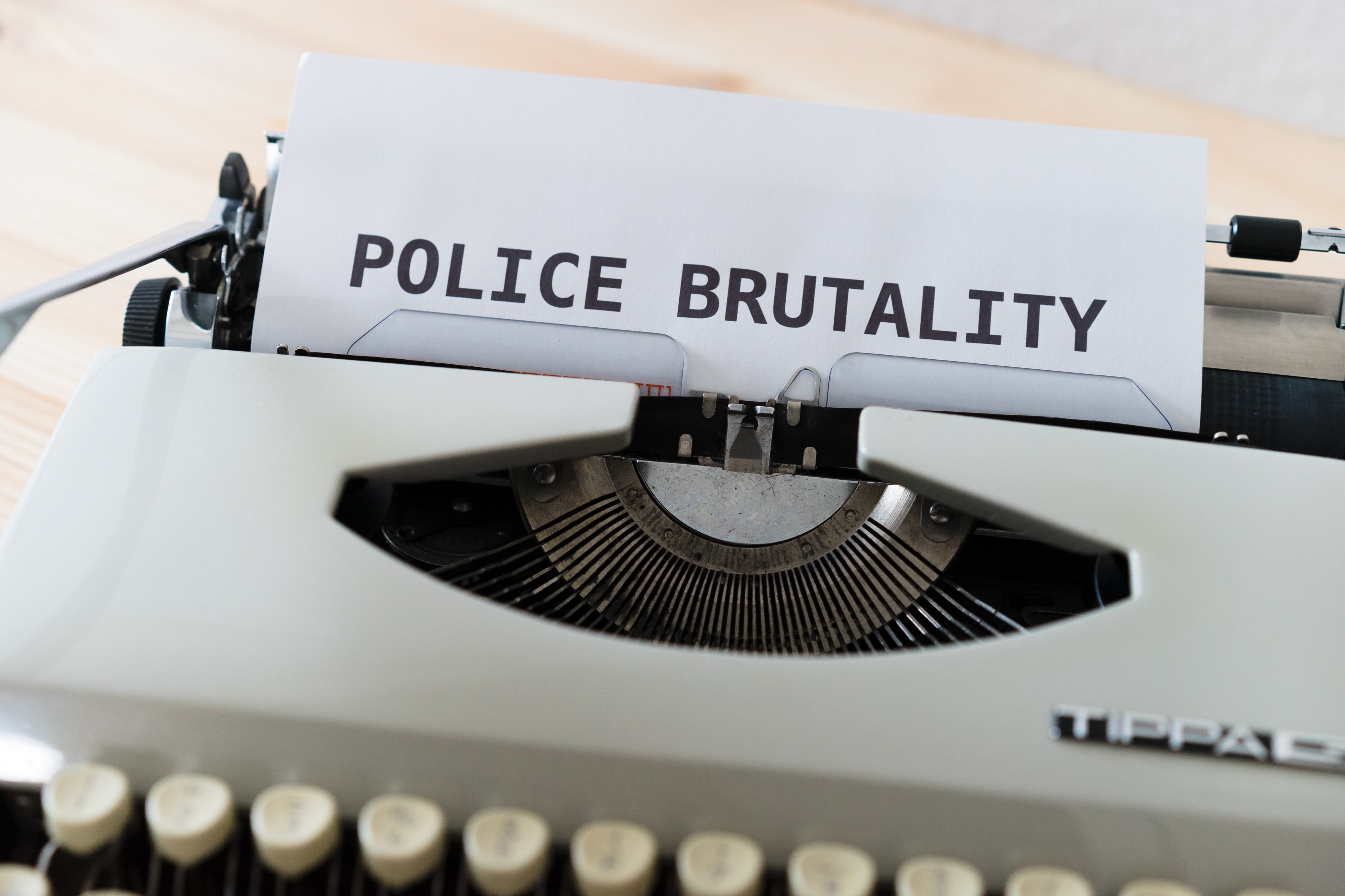 Typewriter with paper saying Police Brutality; image by Markus Winkler, via Unsplash.com.