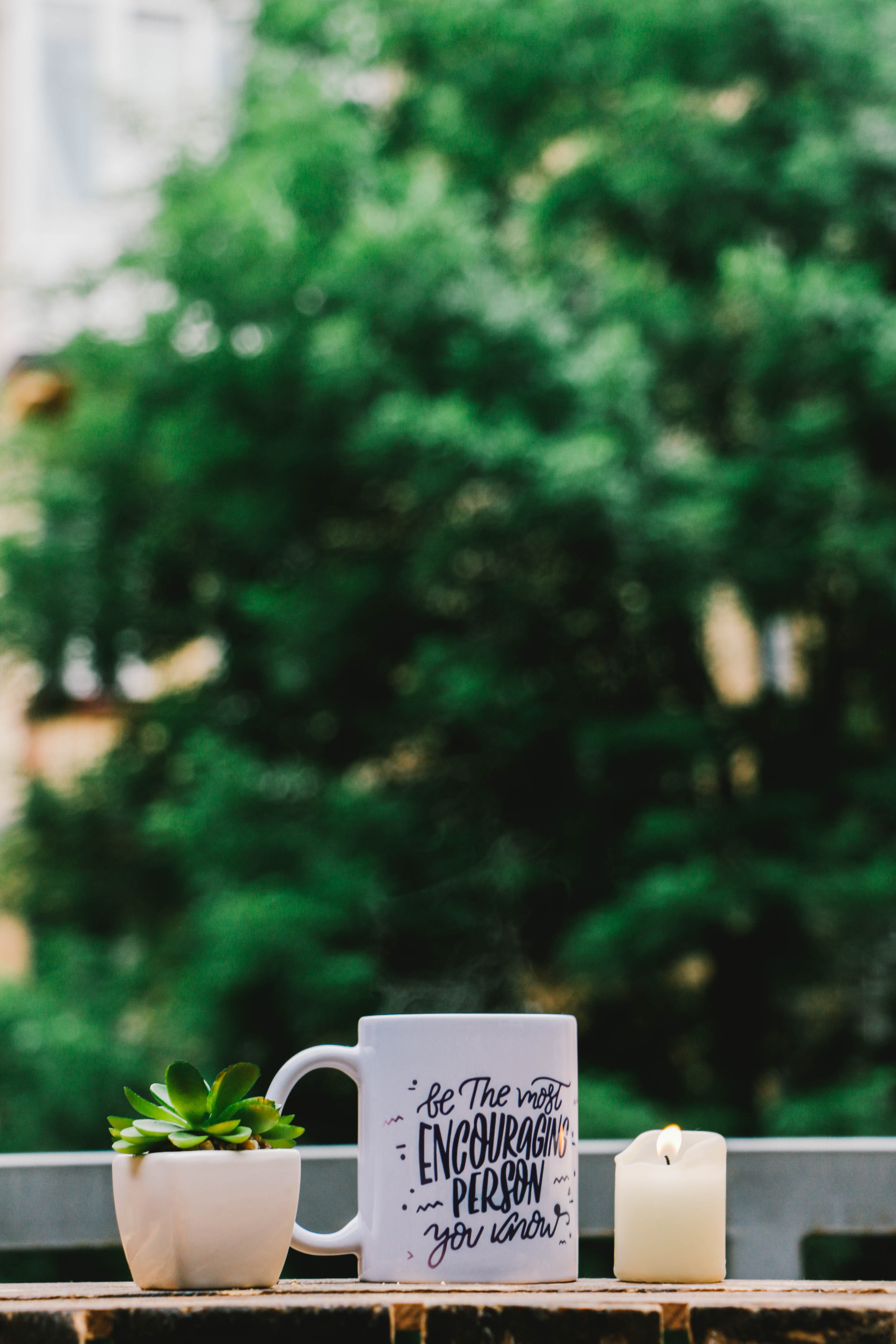 Mug that says, "Be the Most Encouraging Person You Know"; image by John-Mark Smith, via Unsplash.com.