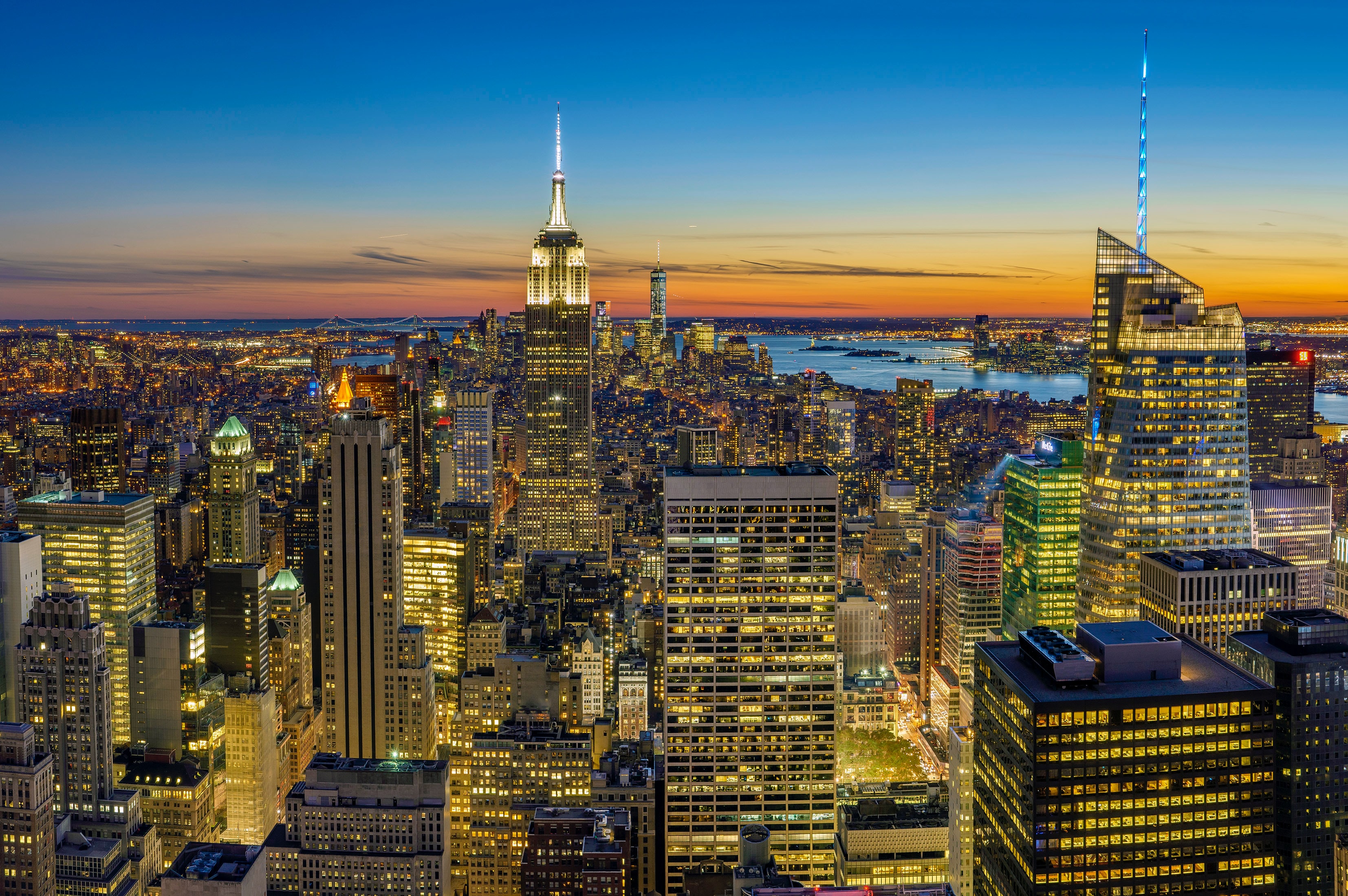 A wide, overhead view of the city of New York at twilight.