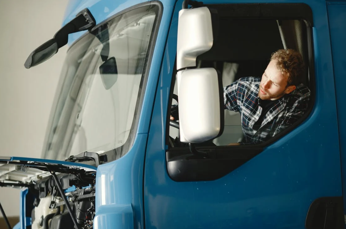 Man in a blue truck; image by Gustavo Fring, via Pexels.com