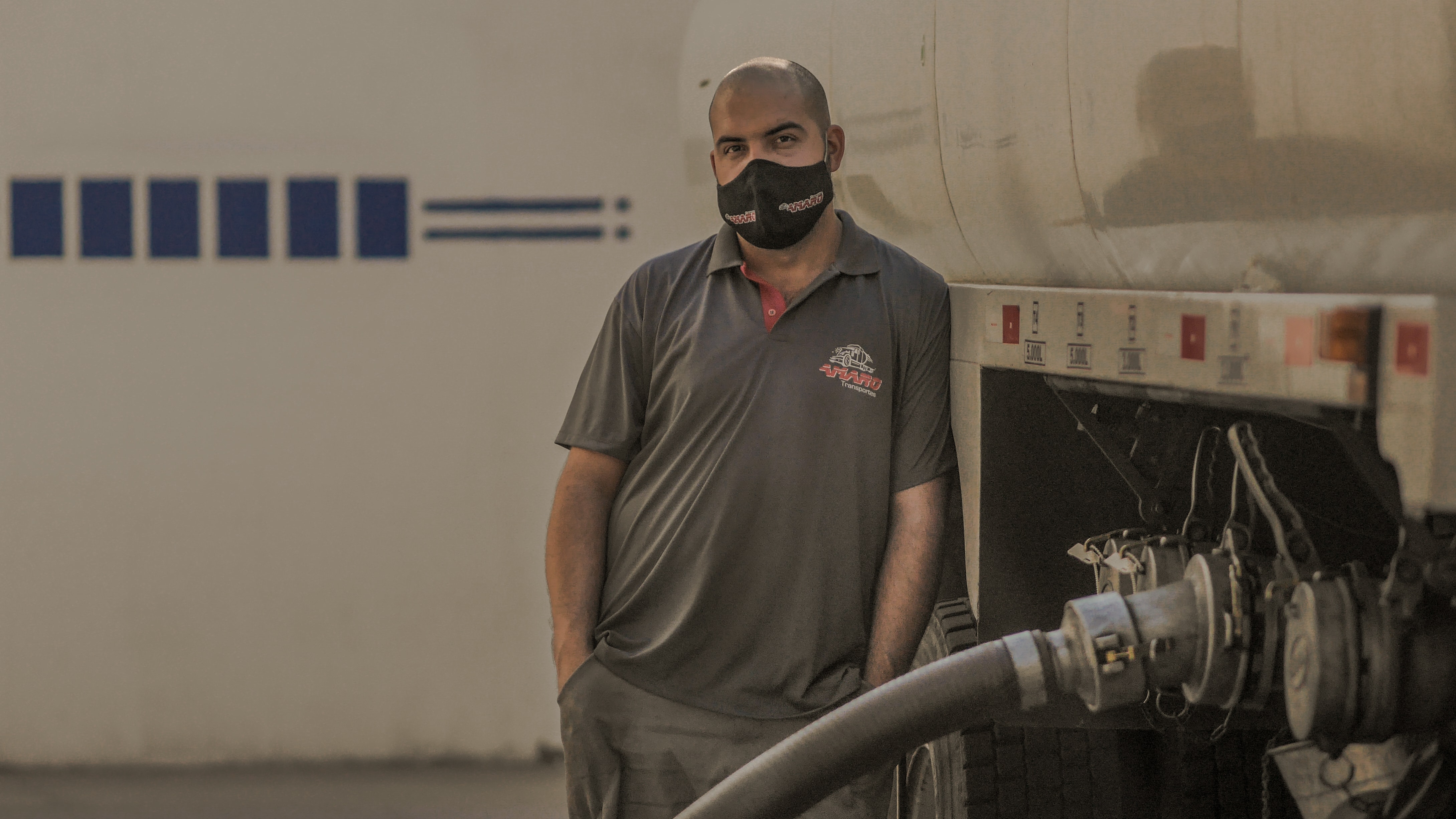 Man with tanker truck and hose; image by Pedro Ceu, via Unsplash.com.