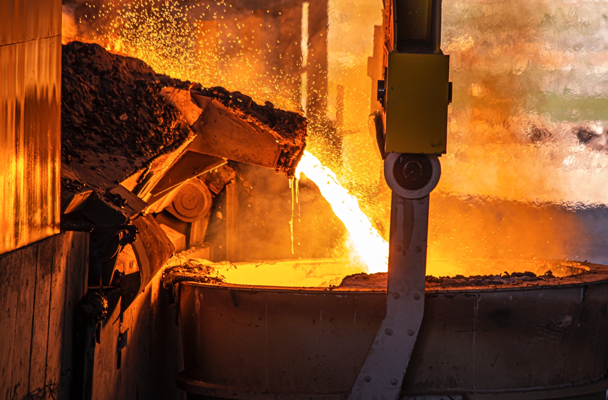 Molten metal being poured at a foundry; image by Yasin Hm, via Unsplash.com.
