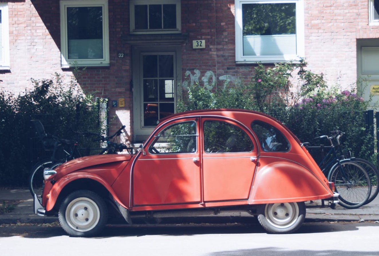 Classic red VW Beetle; image by Nori Lee, via Pexels.com.