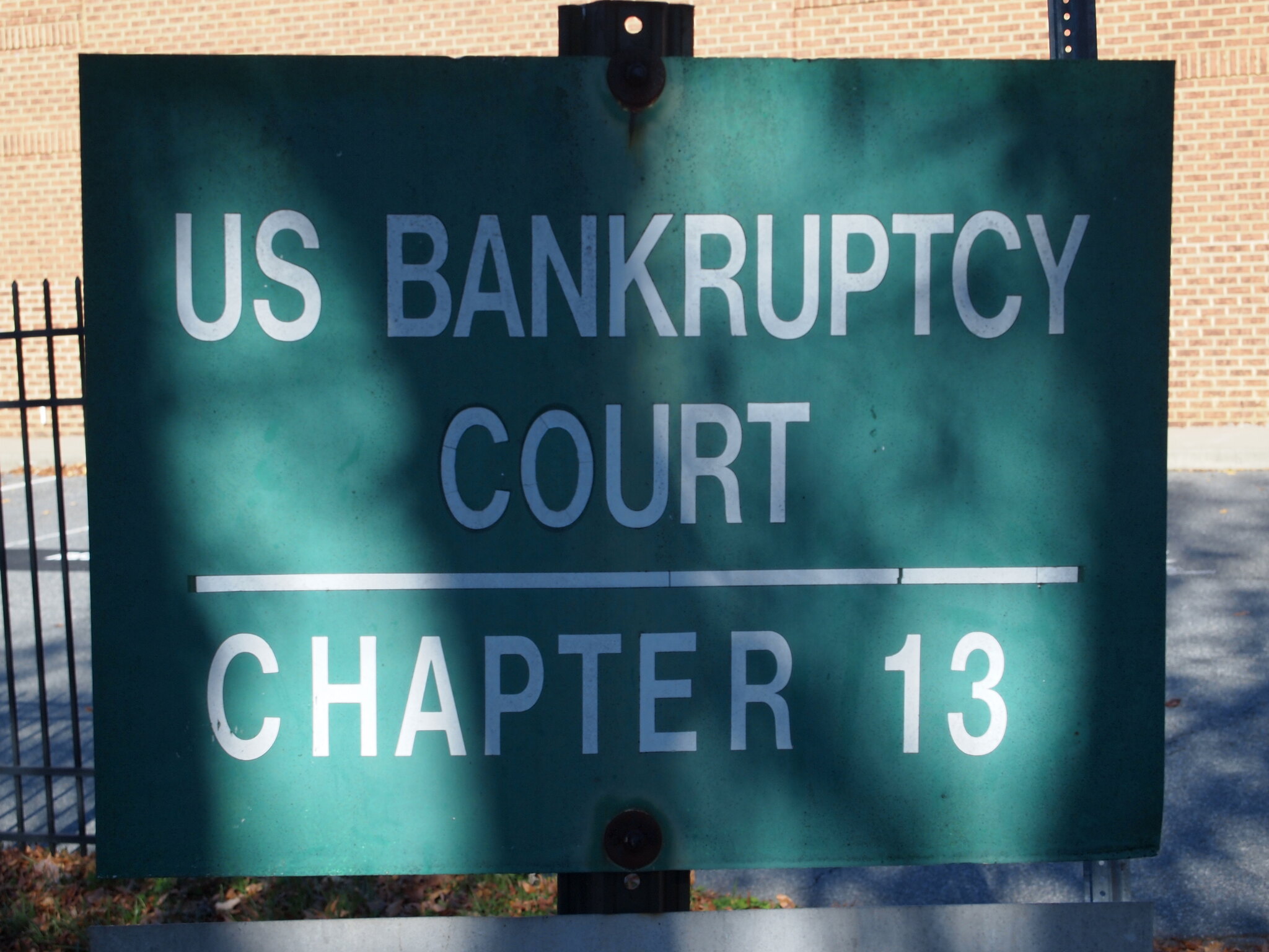 Green and white sign saying US Bankruptcy Court Chapter 13; image by Fried Dough, via Flickr.com, CC BY 2.0.
