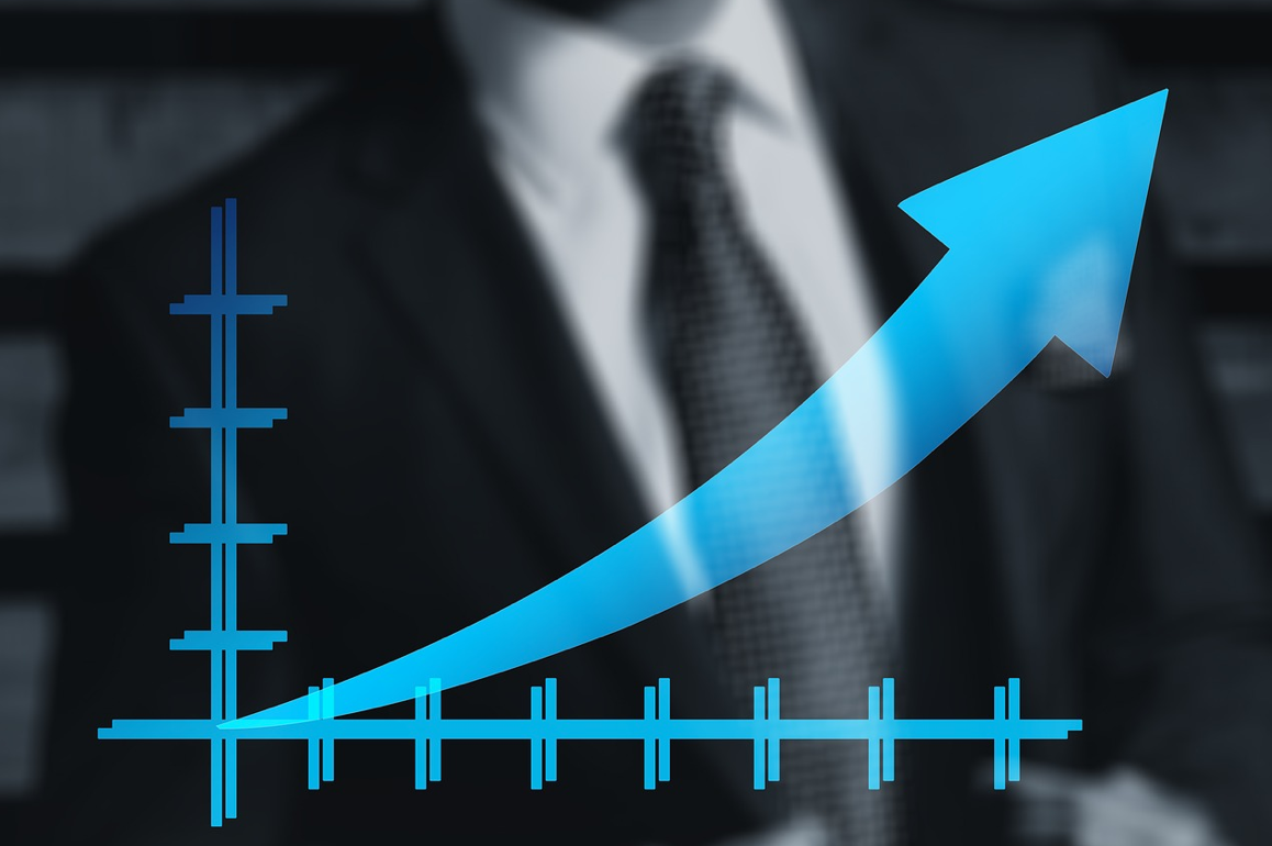 Man in suit with graph with upward trend superimposed; image by Geralt, via Pixabay.com.