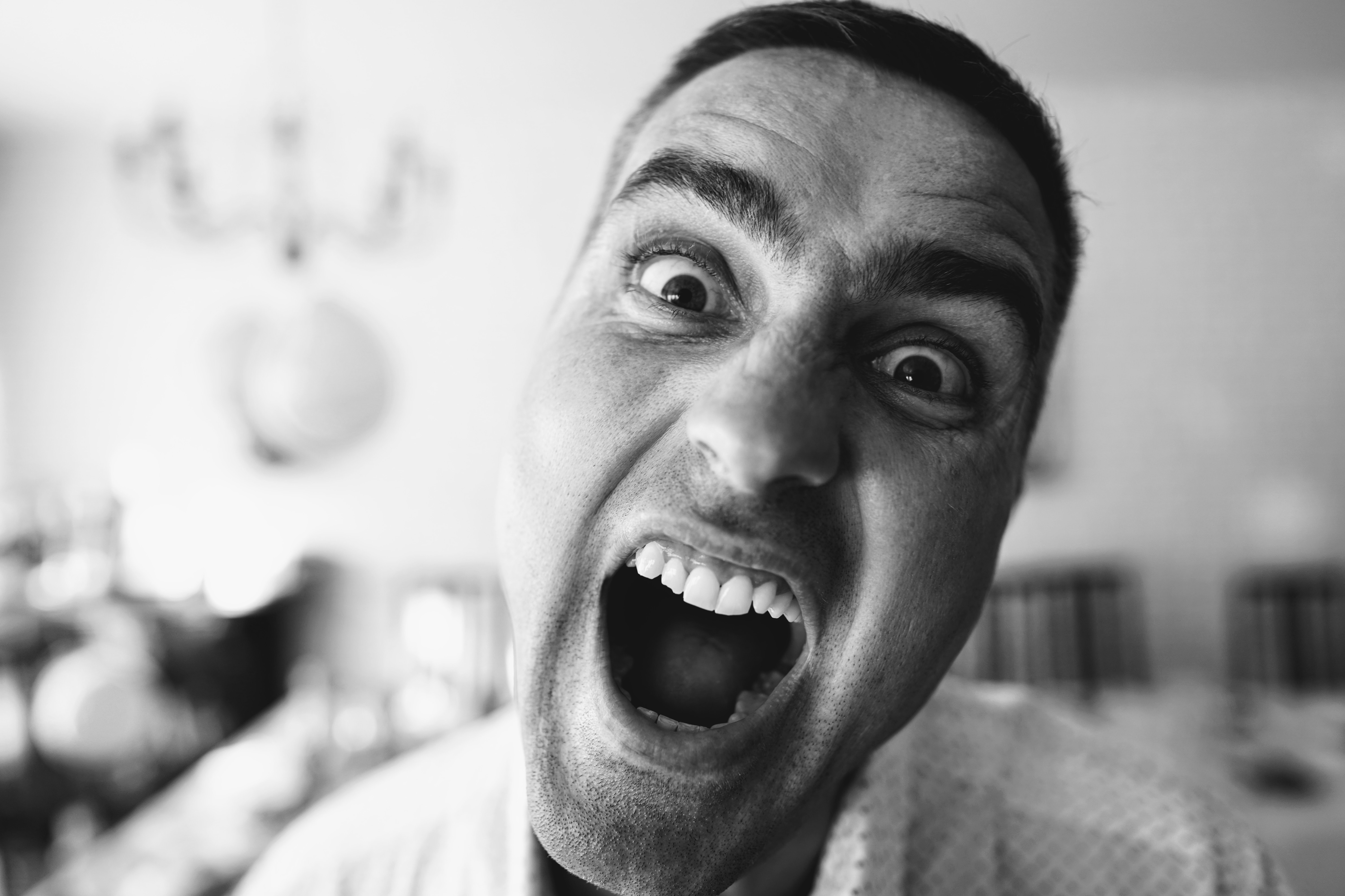 Black and white photo of shouting man; image by Dmitry Vechorko, via Unsplash.com.