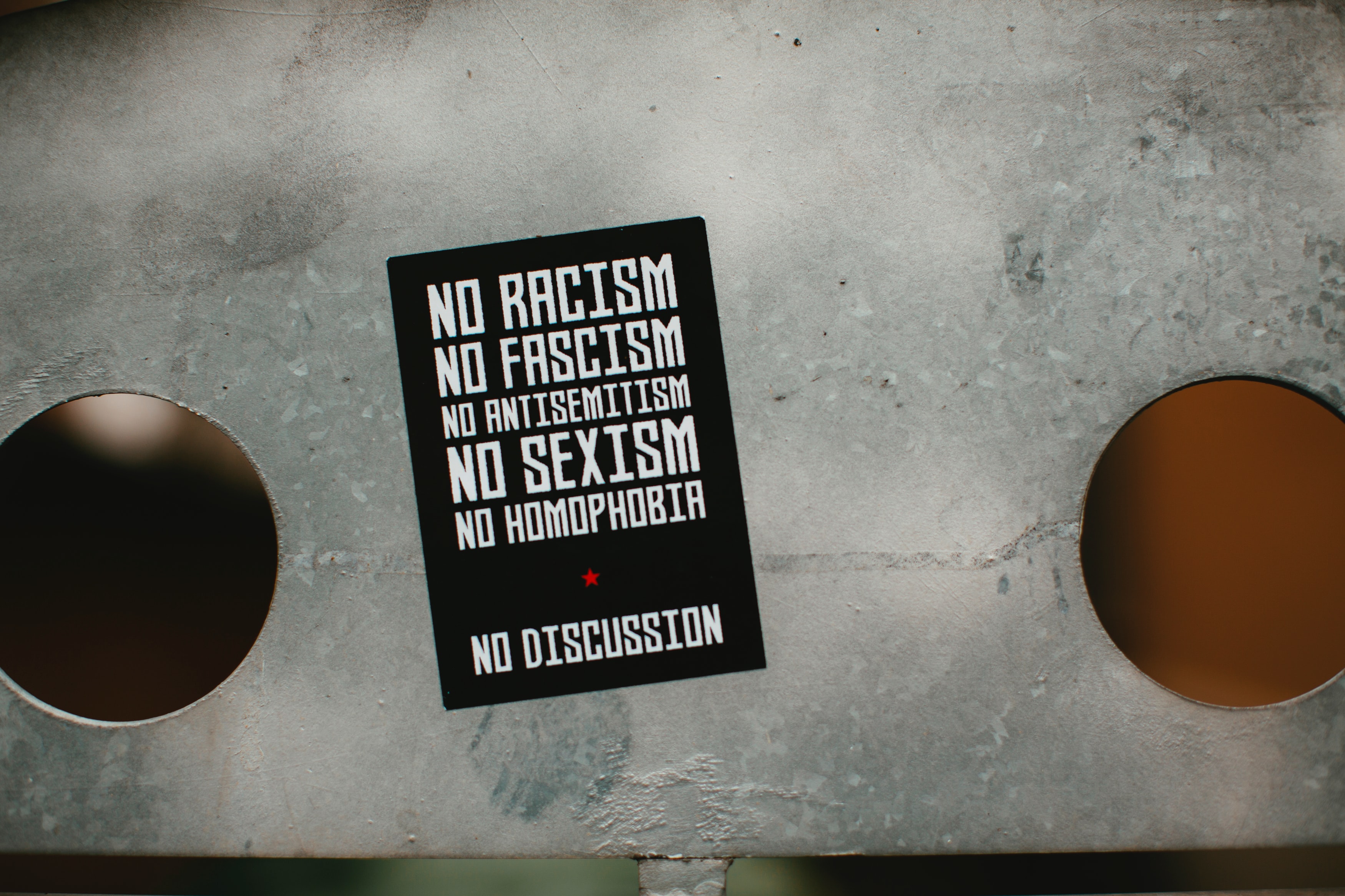 Black card with No Racism, No Facism, No Antisemitism, No Sexism, No Homophobia, No Discussion in white letters; image by Markus Spiske, via Unsplash.com.