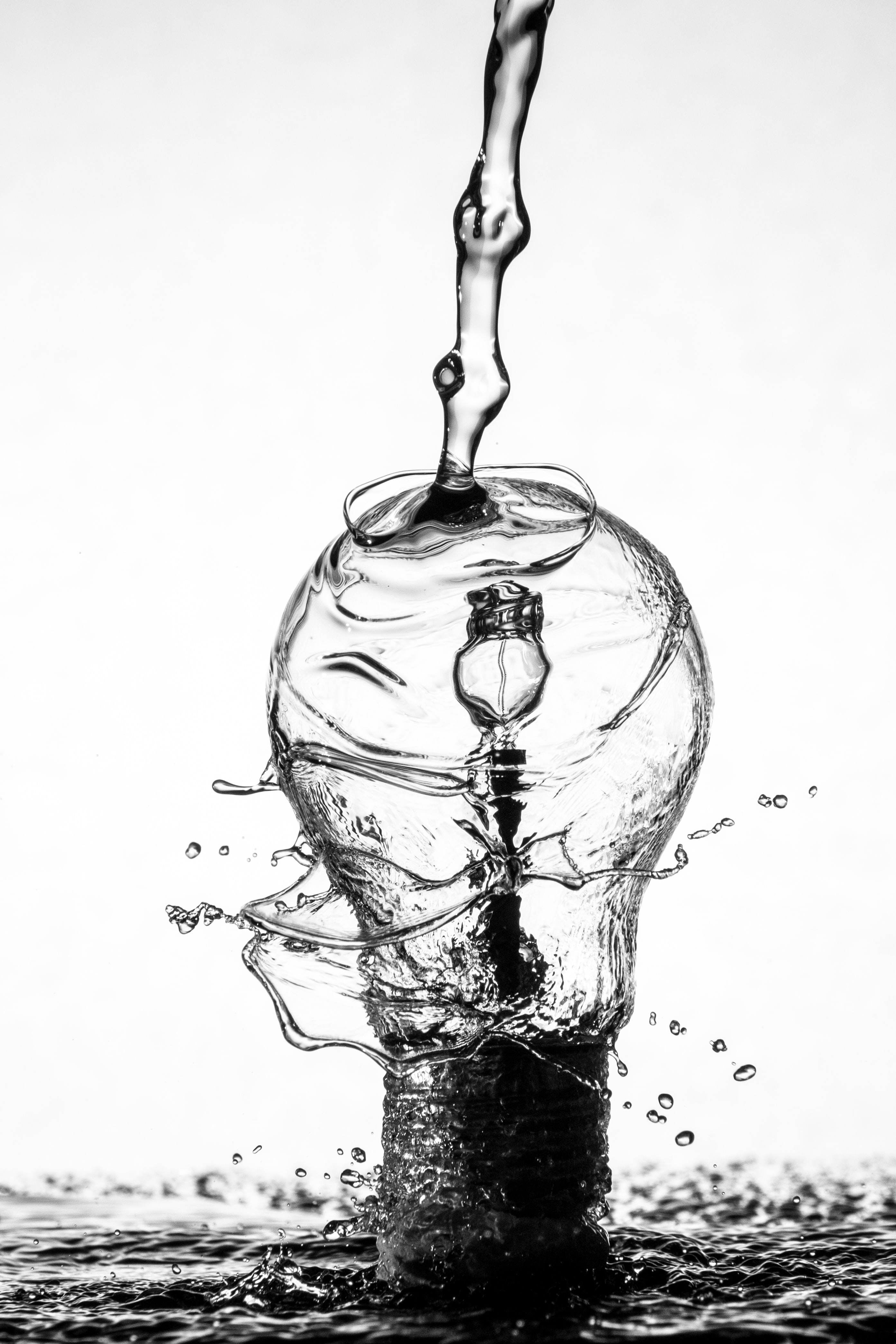 Water pouring over a light bulb; image by Sharon Pittaway, via Unsplash.com.