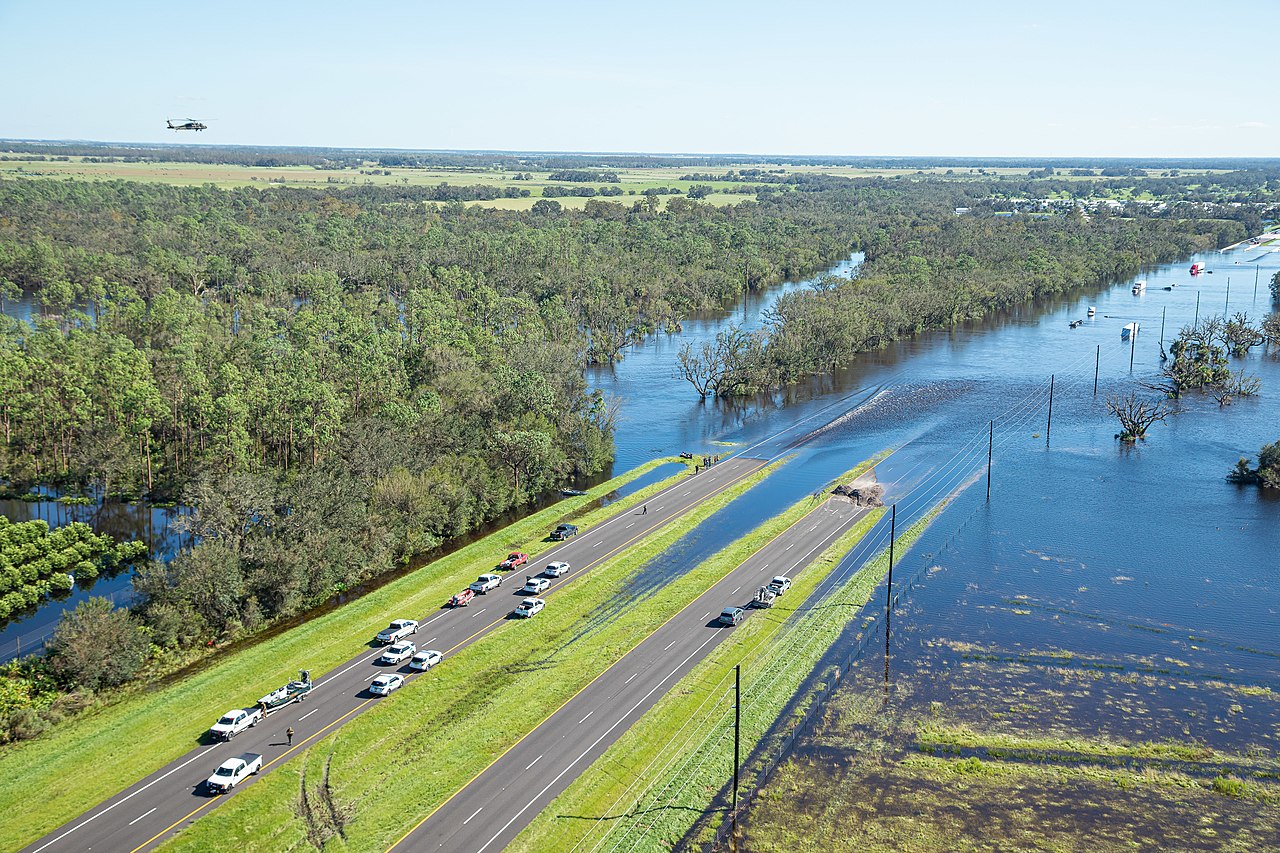 Aerial view of a divided highway partially covered by impassable floodwater.