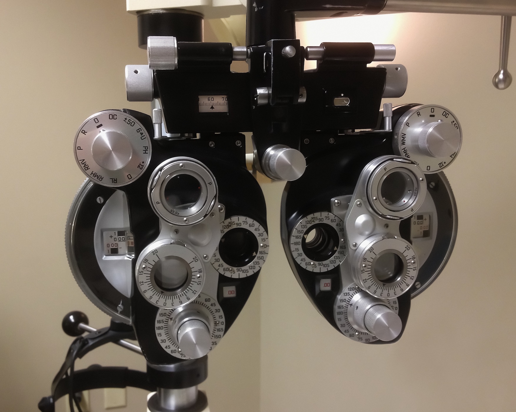 A phoropter - an optometric instrument used by the eye care specialist when performing eye examinations; image by CDC, via Unsplash.com.