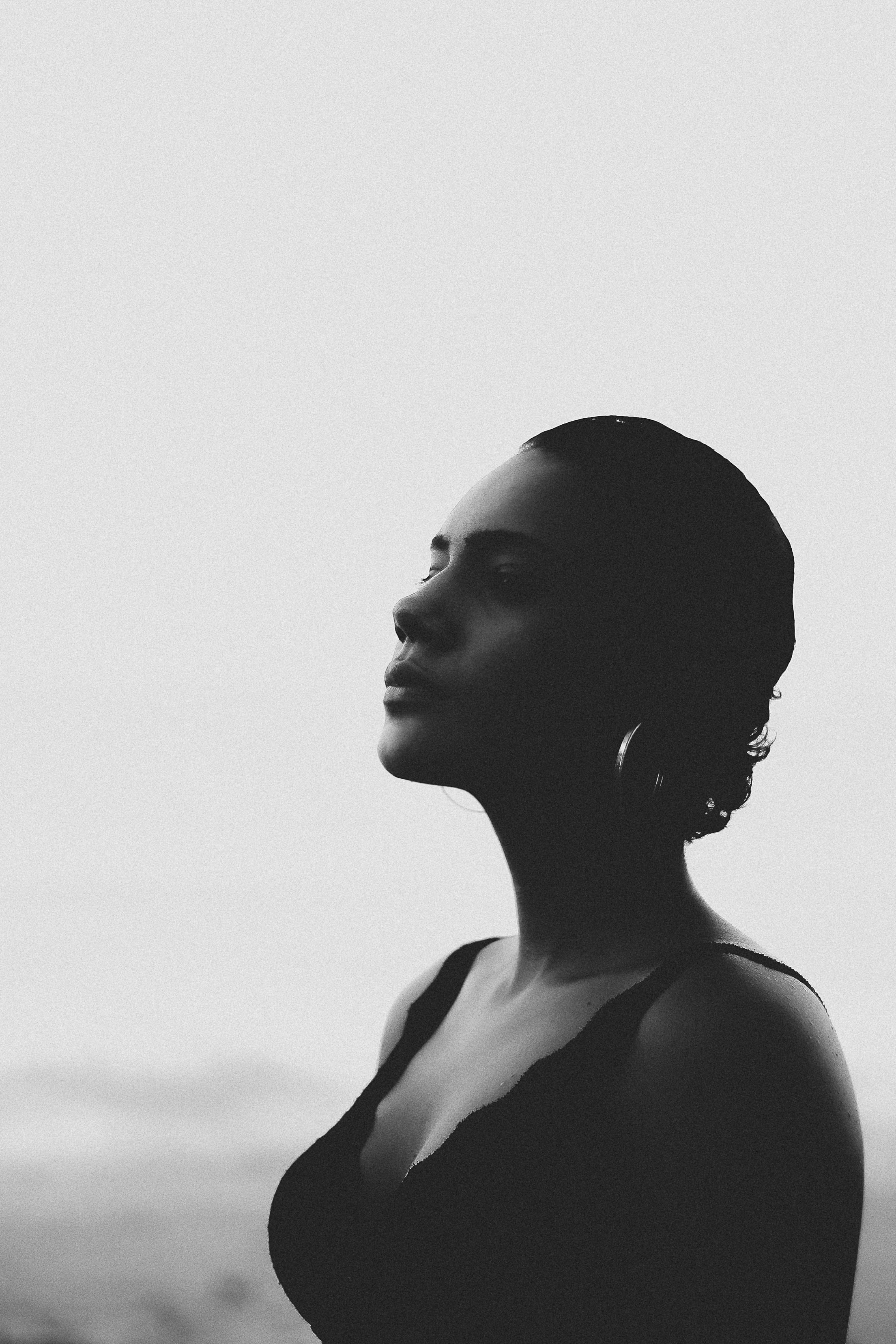 Black and white picture of peaceful woman; image by Caique Nascimento, via Unsplash.com.