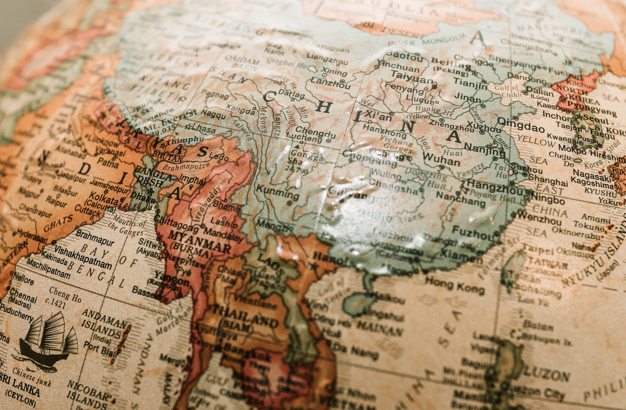 Close-up of globe showing India and China; image by James Coleman, via Unsplash.com.