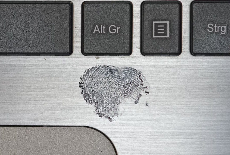Upclose of fingerprint on a keyboard; image by Immo Wegmann, via Unsplash.com.