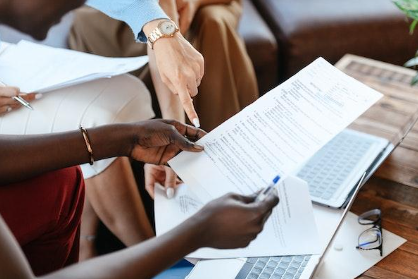 Women reviewing paperwork; image by Alexander Suhorucov, via Pexels.com.