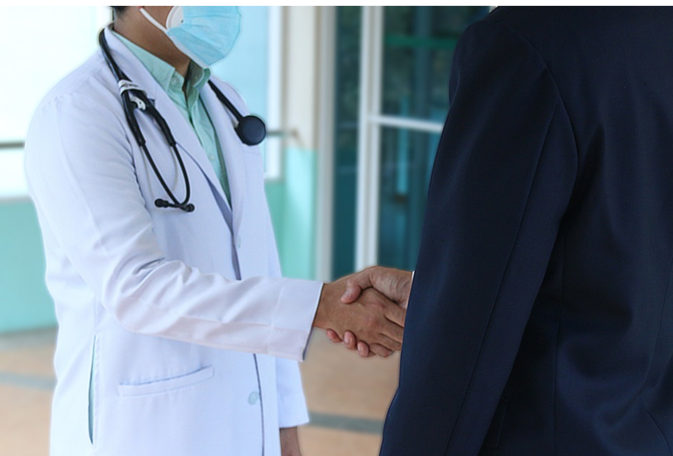 Doctor shaking hands with man in suit; image by herbert11timtim, via Pixabay.com.