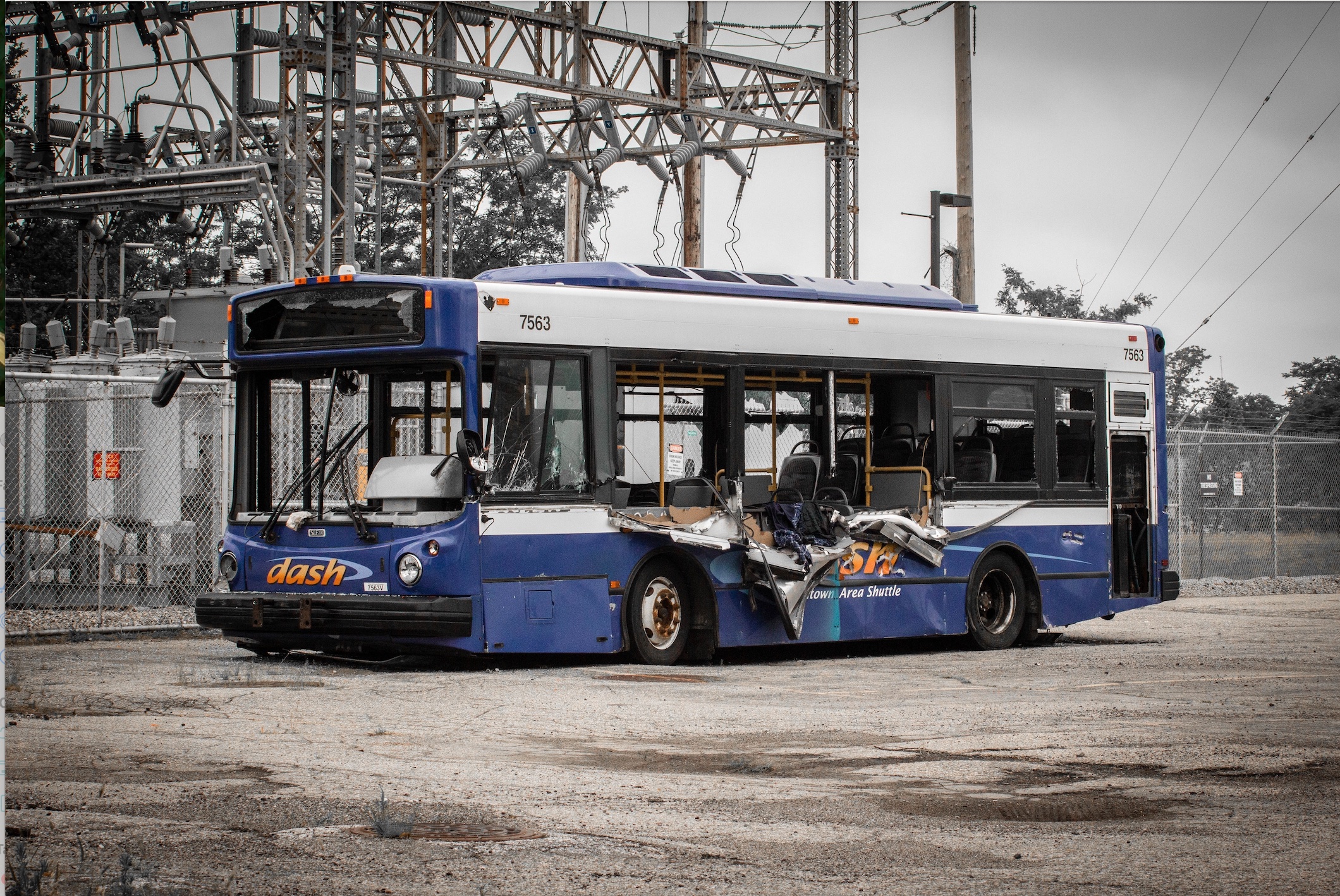 Blue and white bus post-accident with broken windows and damaged side; image by Jonathan Mast, via Unsplash.com.