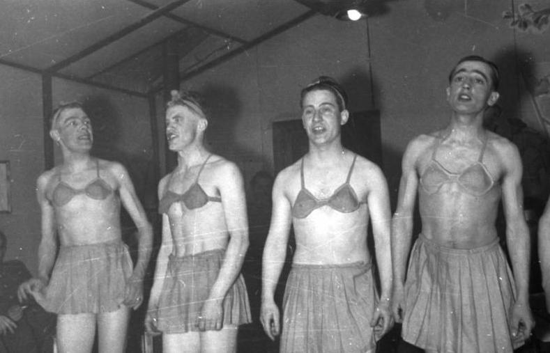 German soldiers wearing bras and skirts, as part of a drag show to entertain the troops.