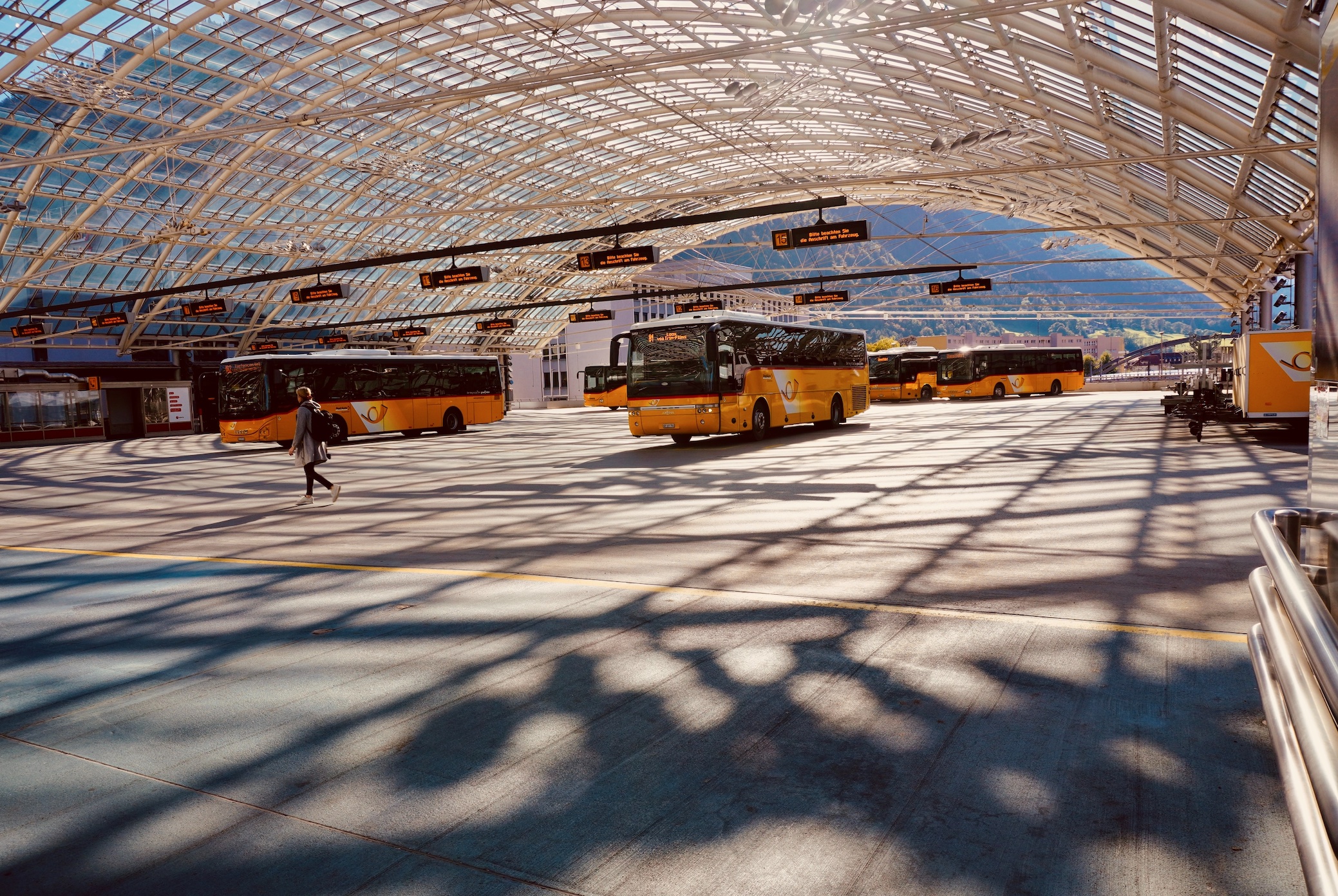 Busses at airport terminal; image by Azzedine Rouichi, via Unsplash.com.