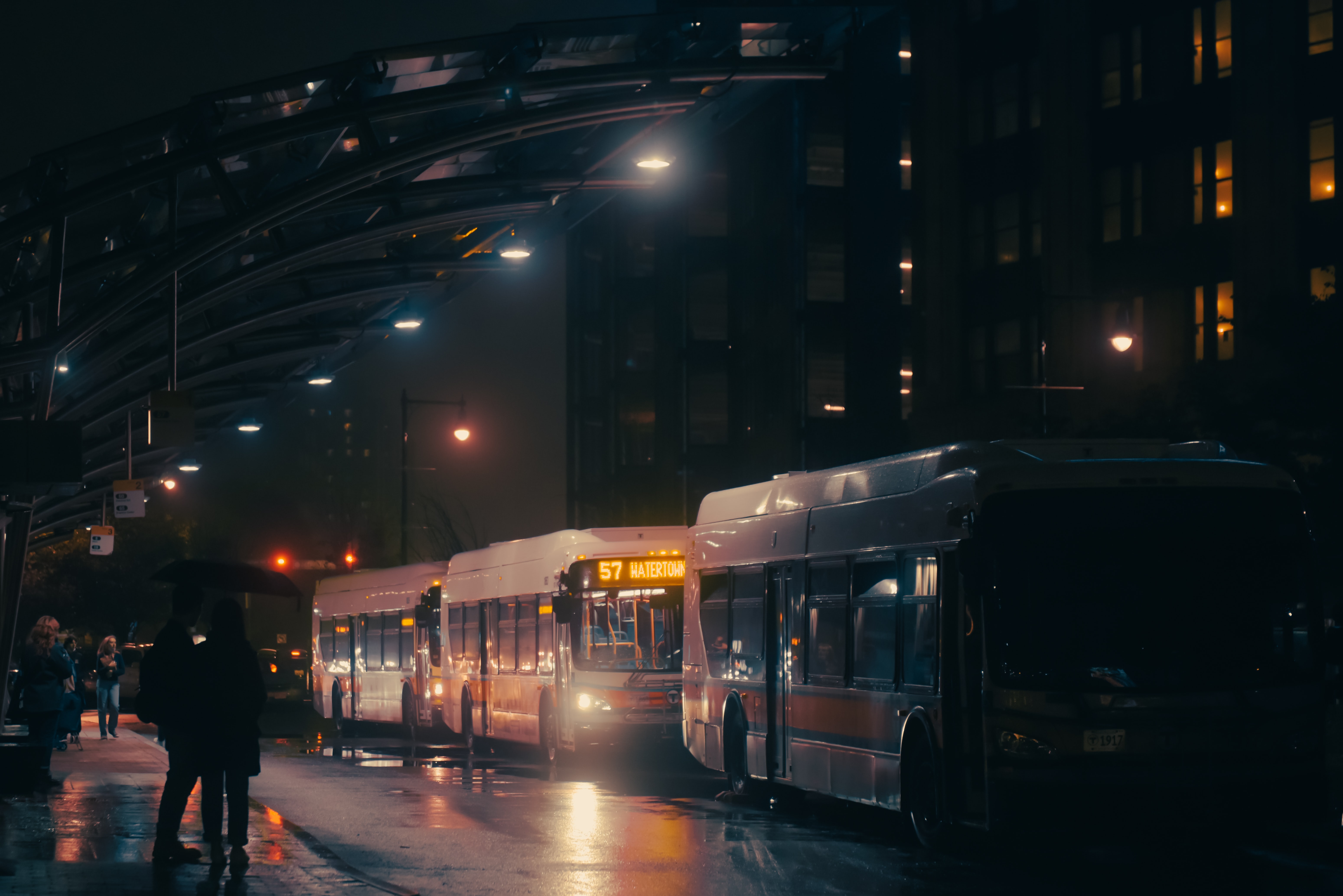 Line of buses at night; image by Andrew Heald, via Unsplash.com.