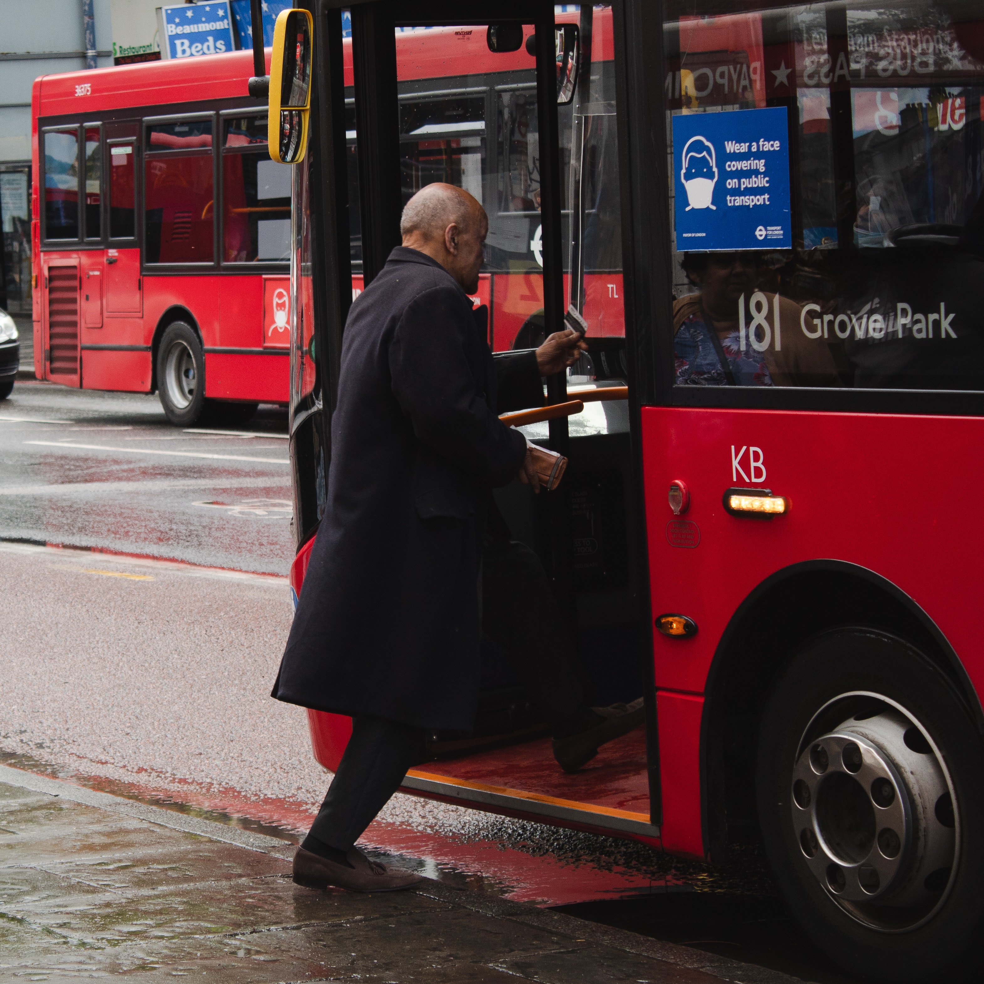 Man boarding red bus; image by Rossano D'Angelo, via Unsplash.com.