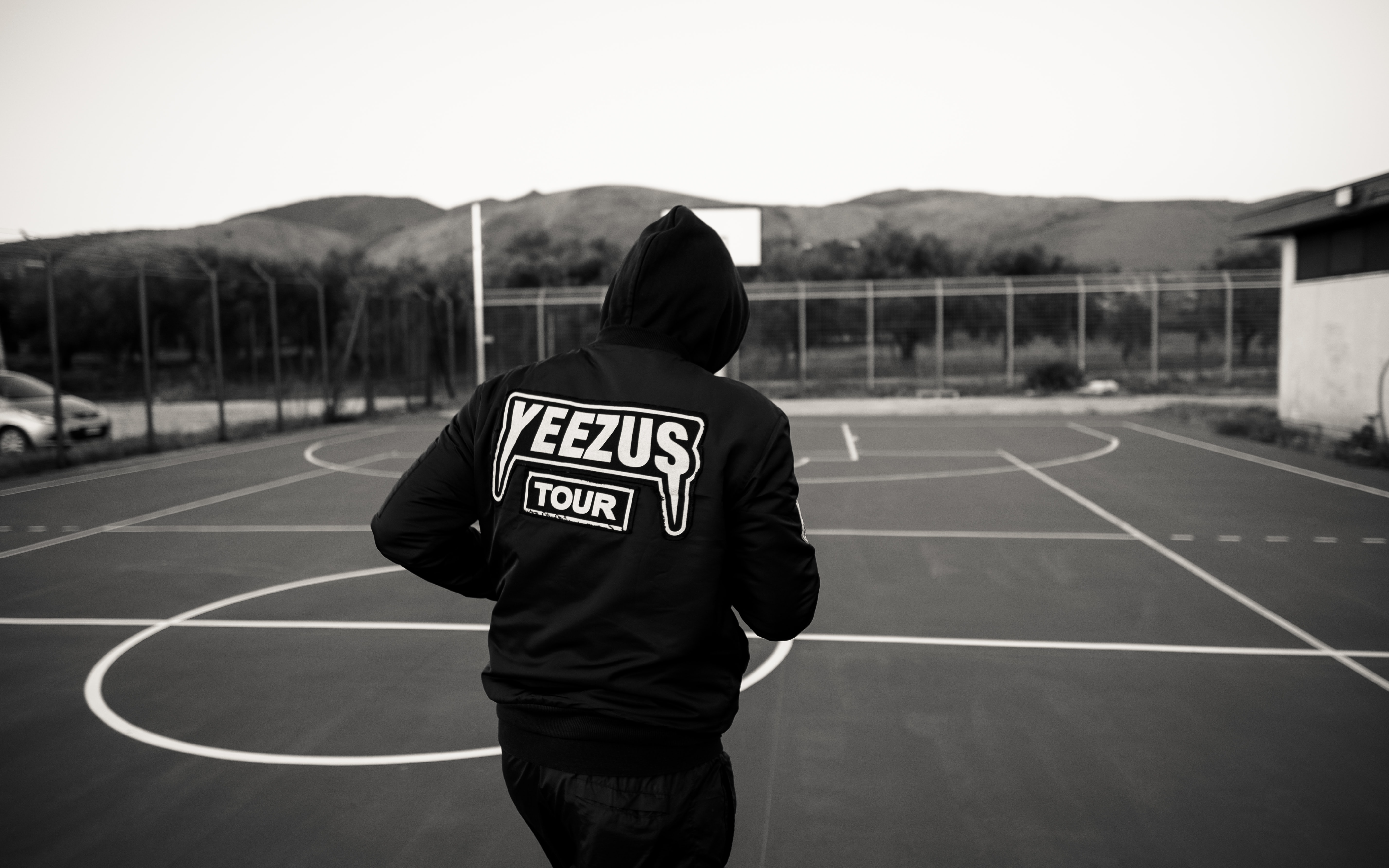Man in black and white Yeezus Tour hoodie; image by Vittorio Cioffi, via Unsplash.com.