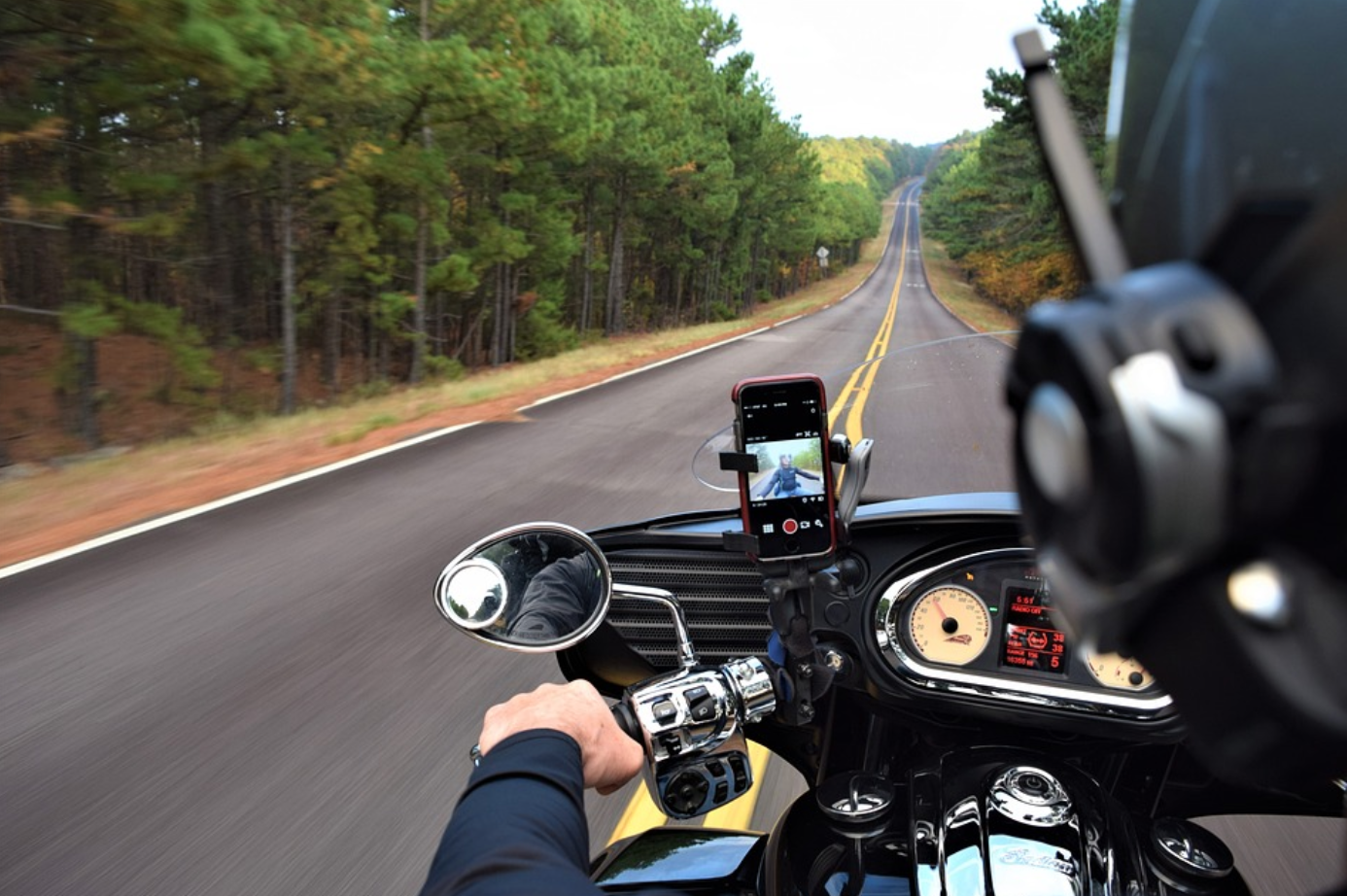 Point of view shot of a motorcycle road trip; image by Cloney, via Pixabay.com.