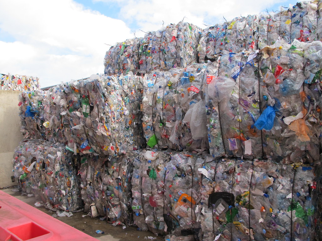 Stacked bales of crushed waste plastic.