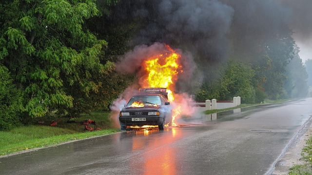 Car on fire on the side of the road; image by vainodesositis, via Pixabay.com.