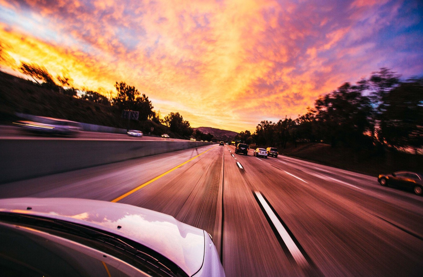 Cars on the road at daybreak; image by Taras Makarenko, via Pexels.com.